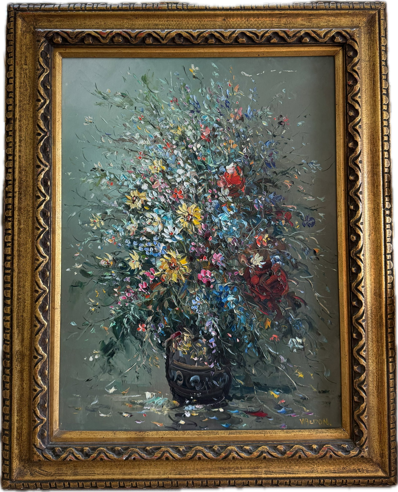 The original or vintage floral still life oil painting on canvas: The original or vintage floral still life oil painting on canvas in an ornate carved gold-tone wooden frame, featuring a large, expressive bouquet of colorful wildflowers in a dark vase against a mute