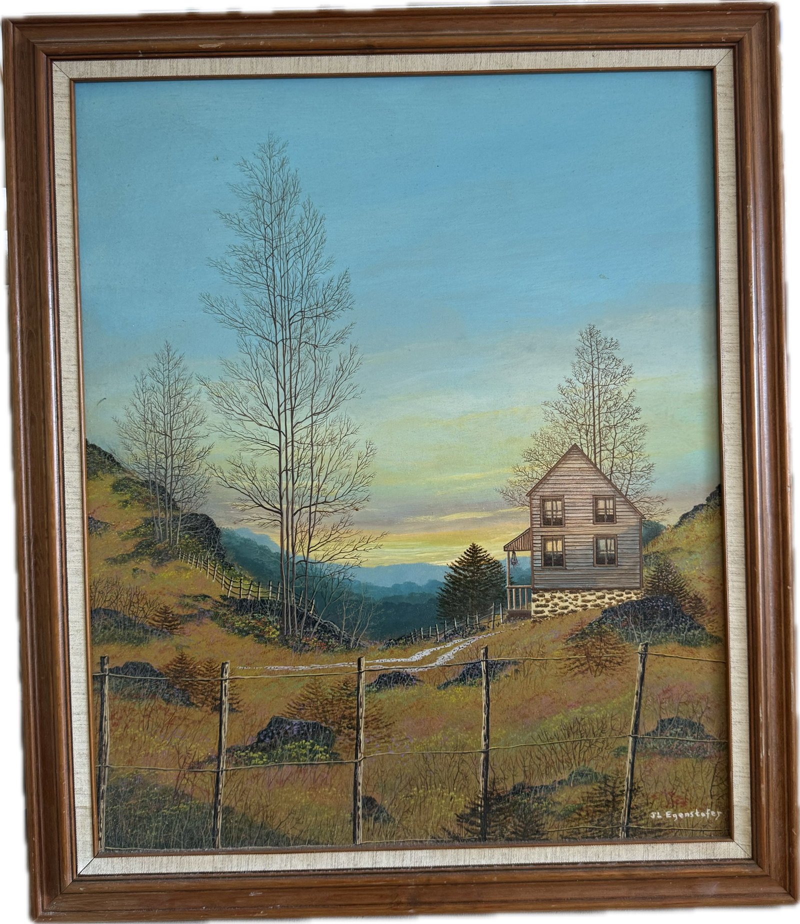 An original landscape oil painting titled "Mountaintail" by American artist John Lewis Egenstafer: An original landscape oil painting titled "Mountaintail" by American artist John Lewis Egenstafer (born 1943), featuring a rustic house, sparse trees, and a wire fence against a sunset sky. 23” 