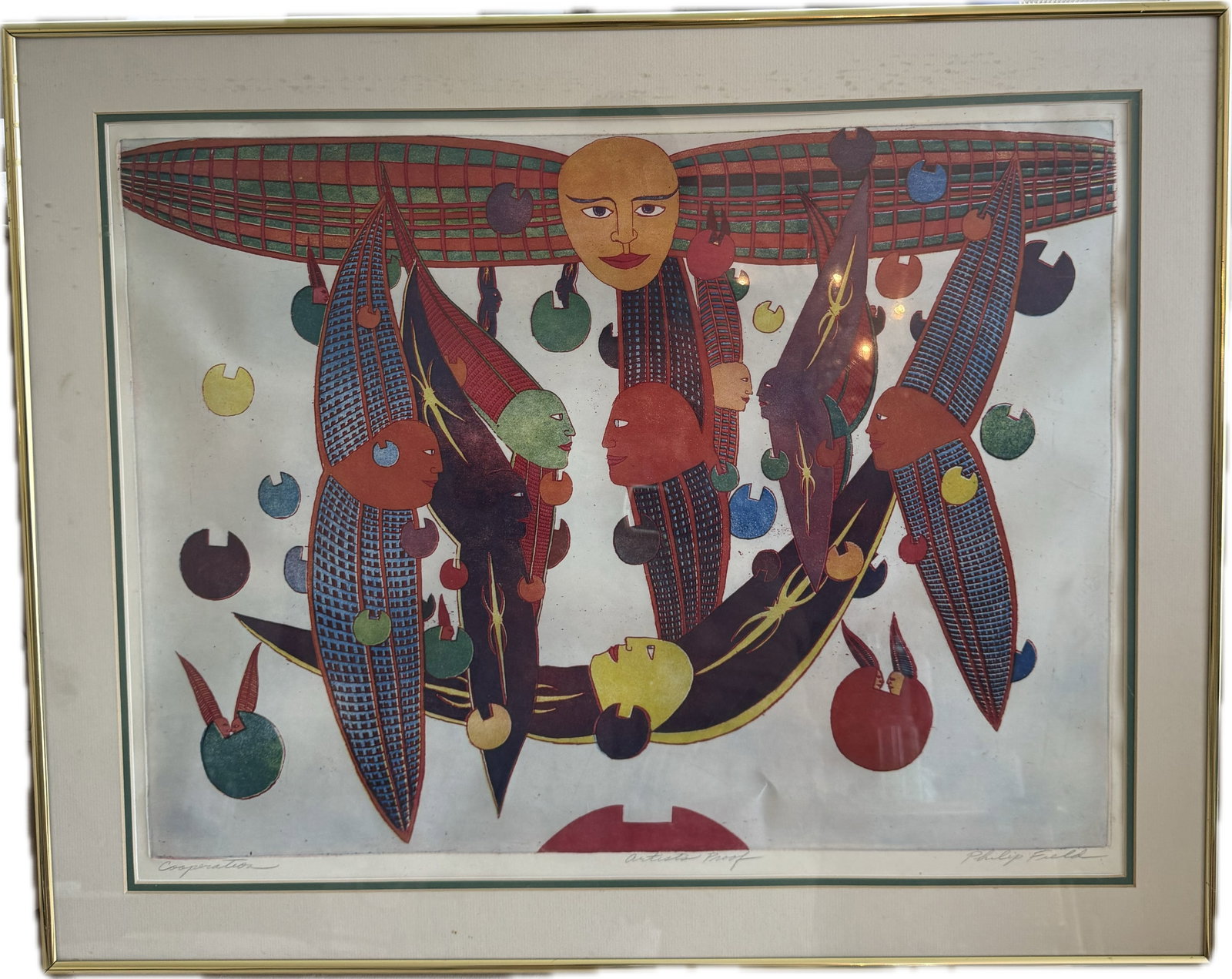 An original framed print titled "Cooperation", pencil-signed by the artist Philip Field: An original framed print titled "Cooperation", pencil-signed by the artist Philip Field and marked as an Artist's Proof.The surrealist artwork features a central large face/sun motif, floating geometr