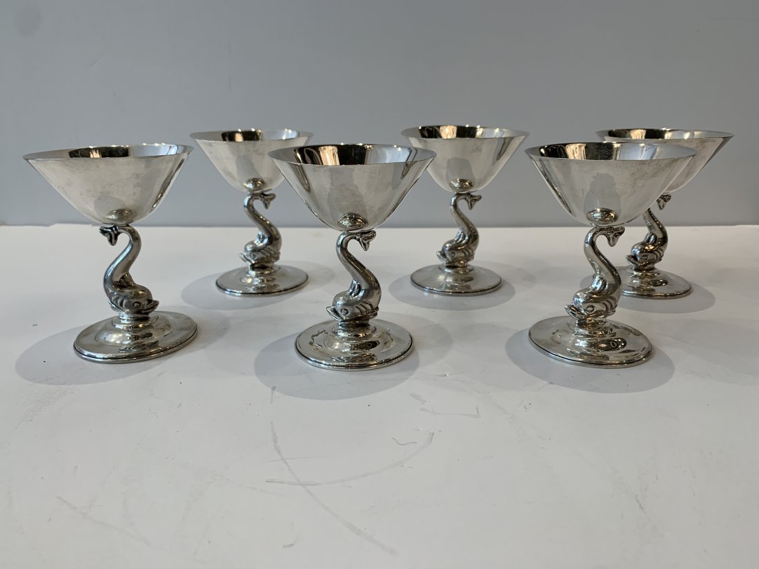 Oscar Bach Sterling Silver Drink Stems Dolphin Motif: Sterling silver drink stems by Oscar Bach with dolphin motif, signed on base good condition with age appropriate wear 4”H X 3.75” diameter