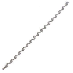 18k Gold Diamond Bracelet: 18k white gold bracelet with approx. 0.70ctw in diamonds. Bracelet is 7 1/8" long and 6.5mm wide. Marked: 750. Weight - 11 grams.