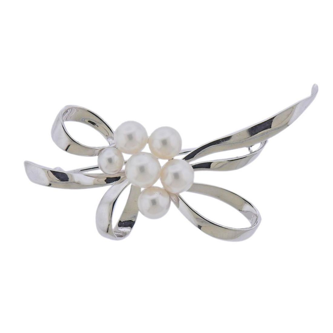 Mikimoto 18k White Gold Pearl Brooch Pin: 18k white gold brooch by Mikimoto, with pearls - 4.8mm to 6.5mm. Brooch measures 55mm x 31mm. Marked: M. 750. Weight- 8.9 grams.