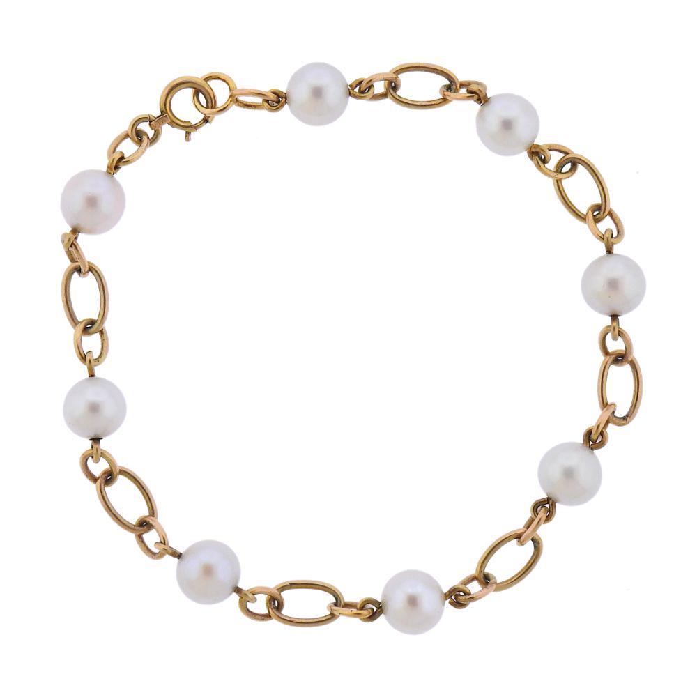 Mikimoto 14k Gold Pearl Bracelet: 14k Gold bracelet crafted by Mikimoto set with 6.5mm pearls. Bracelet measures 7 1/2'' long. Marked - Makers mark, 14k. Weight 6.1 grams.