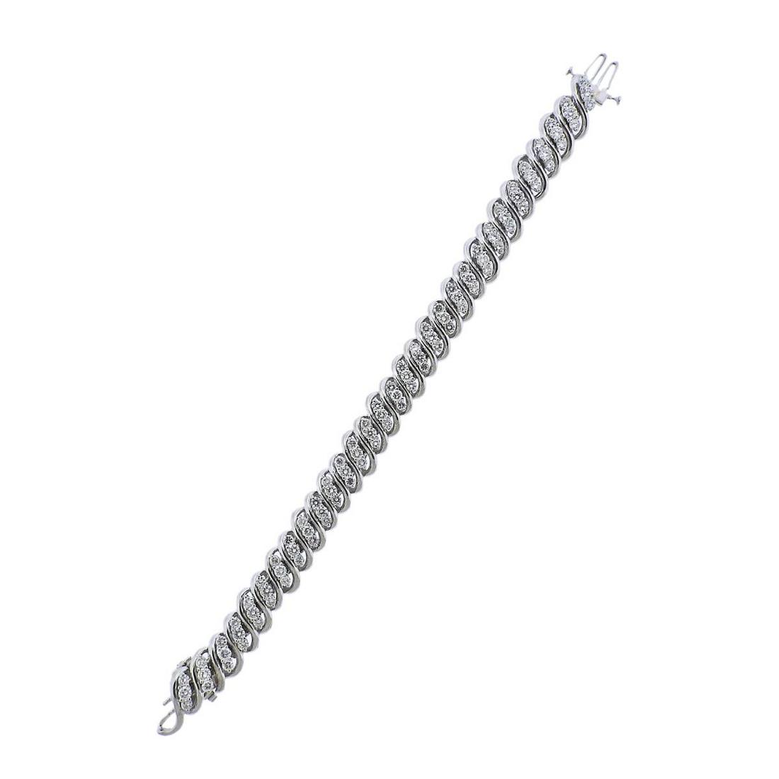 14k Gold 6ctw Diamond Bracelet: 14k white gold bracelet, with approx. 5.70-6.00ctw in VS1-Si1/G-H diamonds.. Bracelet is 6.5" long (extra link is 5/8" long) width is 12mm. Marked 14k. Weight - 45.8 grams (with the extra link).