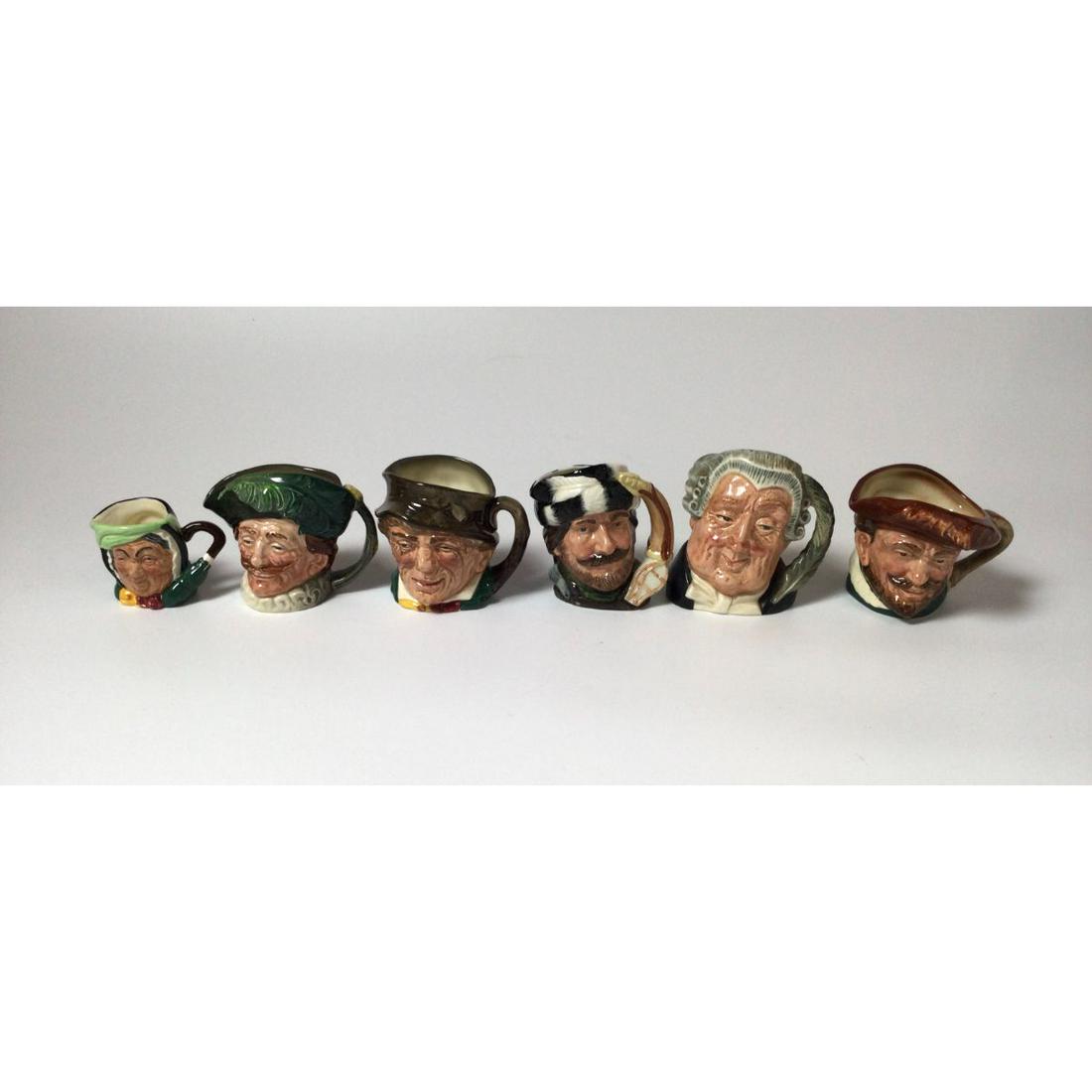 Lot of 6 Royal Doulton Toby Jugs: 4” to 2 1/4” tall. From Right to left Sairey Gamp, The Cavalier,Paddy, The Trapper, The Lawyer, and Drake