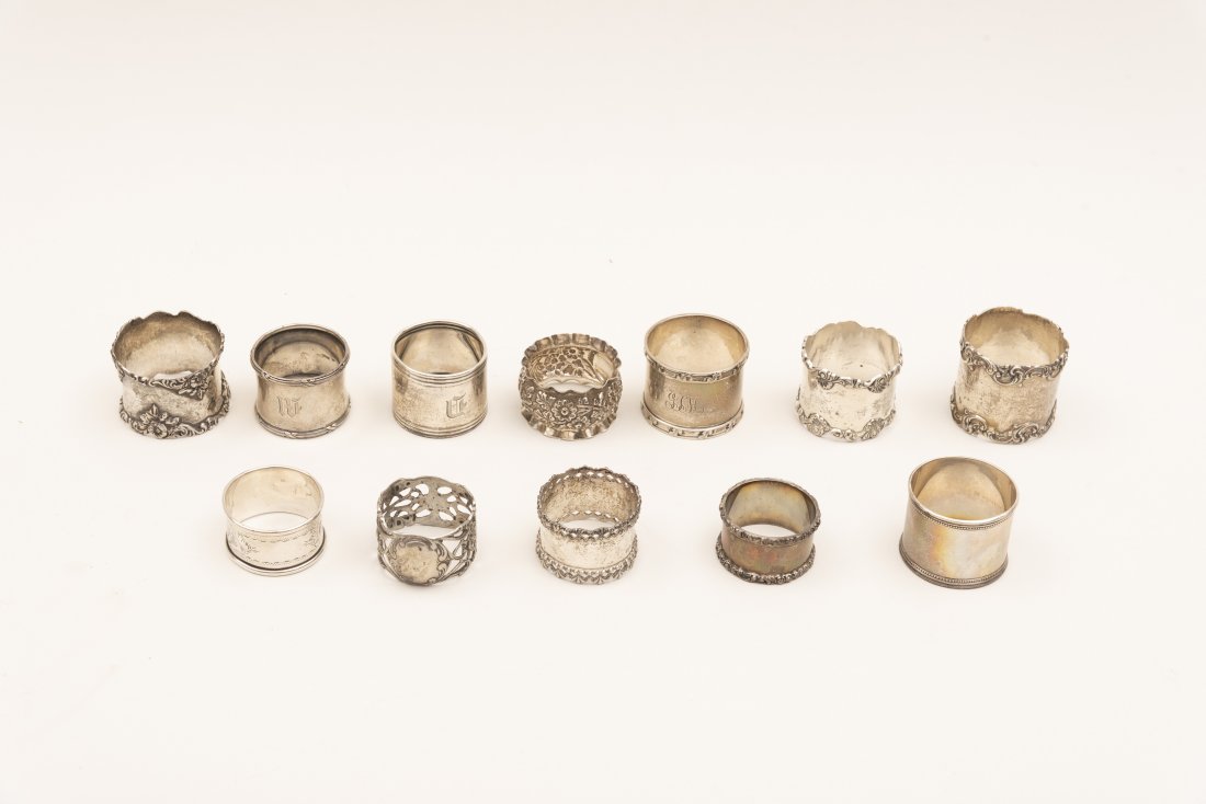 Twelve American Sterling Silver Napkin Rings Weight: Twelve American Sterling Silver Napkin RingsVarious makers and patterns including two unmarked and one .800 silver.Weight 10.2 troy ounces