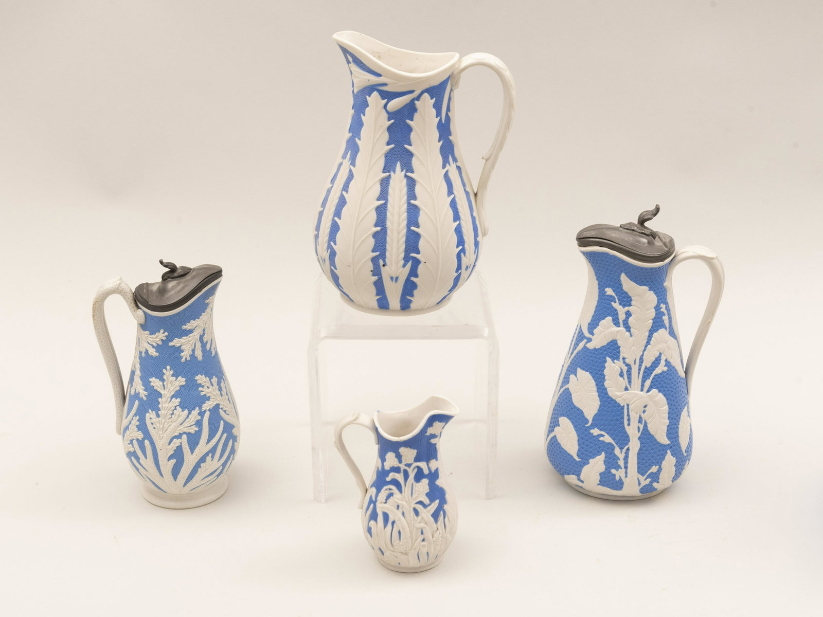 Four 19th century English Parian Smear Glaze Ceramic: Four 19th century English Parian Smear Glaze Ceramic PitchersAll with blue ground and white coral and foliate designs three marked Beech & Hancock and the fourth unmarked.Heights range from 9 1/2 to 5