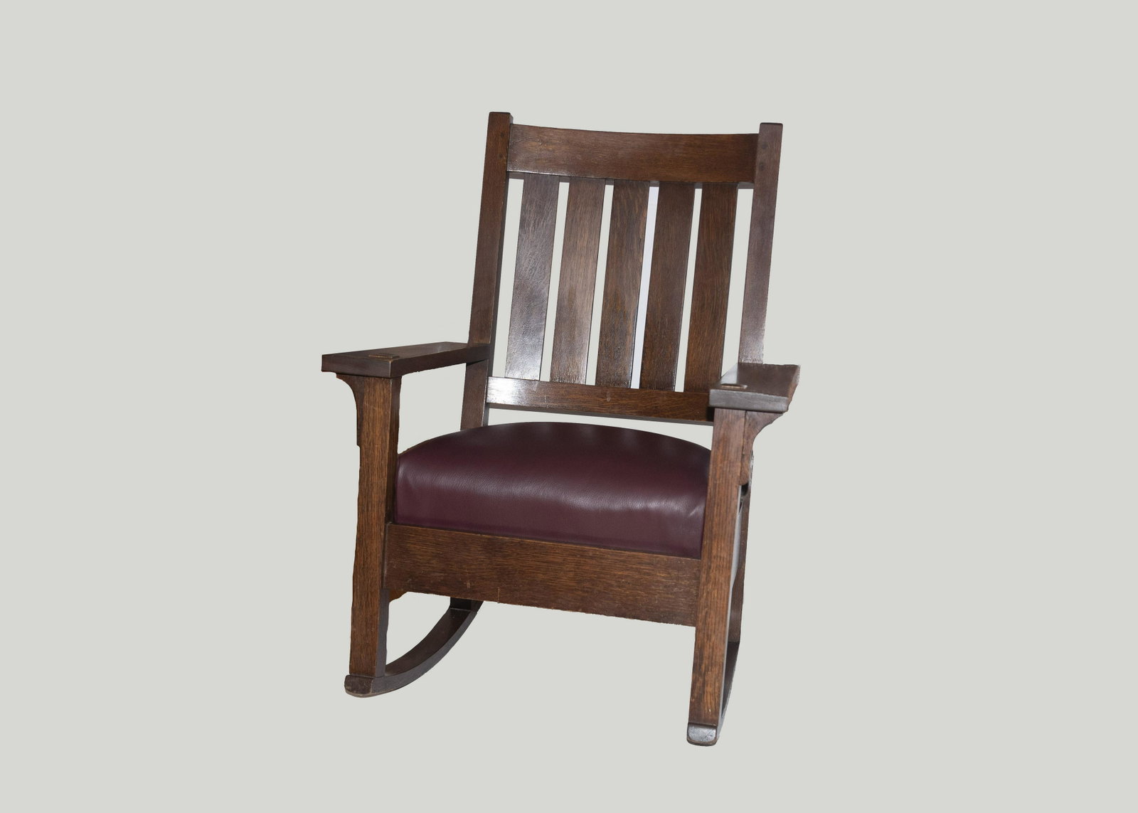 Early Gustav Stickley Arts & Crafts rocker: Early Gustav Stickley Arts & Crafts rocker with upholstered seat; Gustav Stickley red decal located on the interior of rear seat rail.