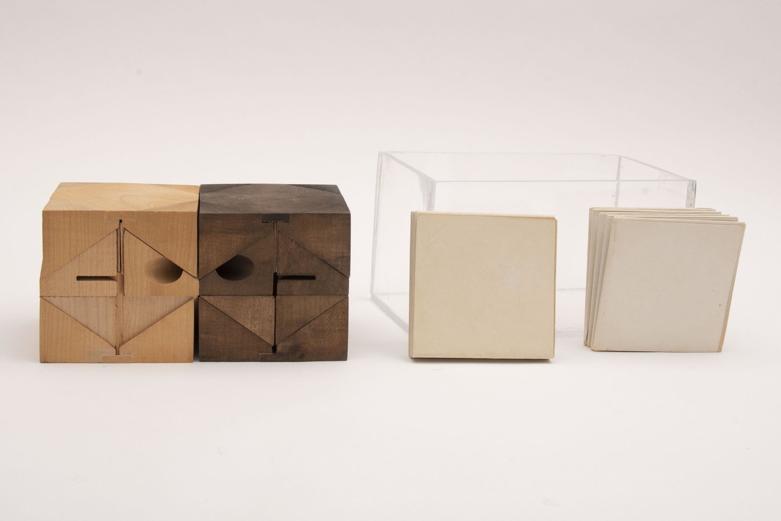 Chess set by Charles Owen Perry (American, 1929-2011).: Chess set by Charles Owen Perry (American, 1929-2011). One side executed in pinewood the opposing side in walnut-stained pine wood. Puzzle design-construct two cubes, each composed of 16 pieces. Two l