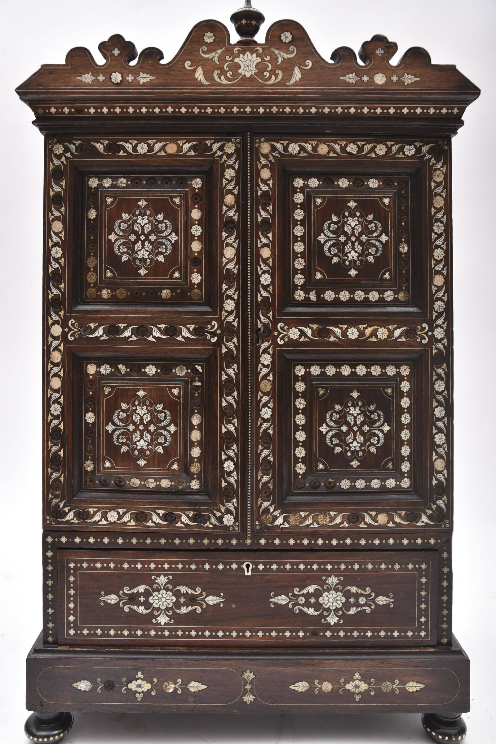 Early 20th Century Hanging Wall Cabinet 29 x 17 1/2 x 9: Early 20th Century Hanging Wall Cabinet Urn form finial centering a carved shaped cornice above a pair of hinged panel cupboard doors above a single drawer with dovetail construction. This piece has a