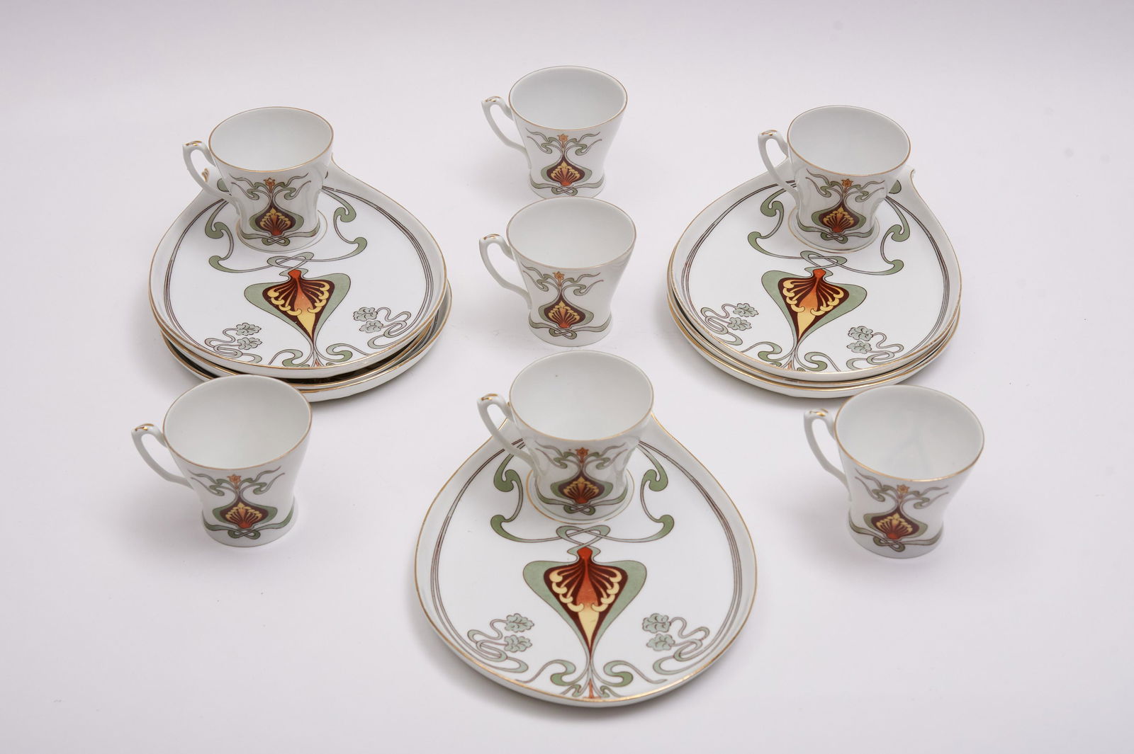 7 Austrian Art Nouveau Porcelain Tea or Luncheon Sets: 7 Austrian Art Nouveau Porcelain Tea or Luncheon SetsThe elongated platter with stylized Art Nouveau pattern, each holding a tea cupLength of platter 9"