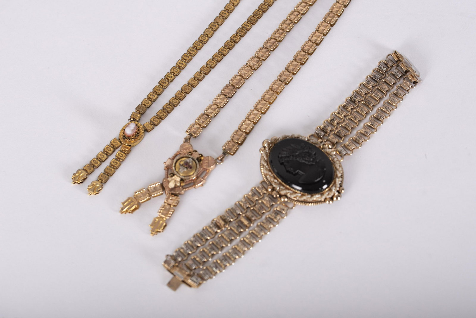 Three Pieces Vintage and Antique Jewelry, Large Cameo: Three Pieces Vintage and Antique Jewelry, Large Cameo Bracelet and Two Necklaces bracelet with three strands linked, the Bakelite cameo mounted with seed pearls surround on frame, 2 1/4 x 1 3/4 inches