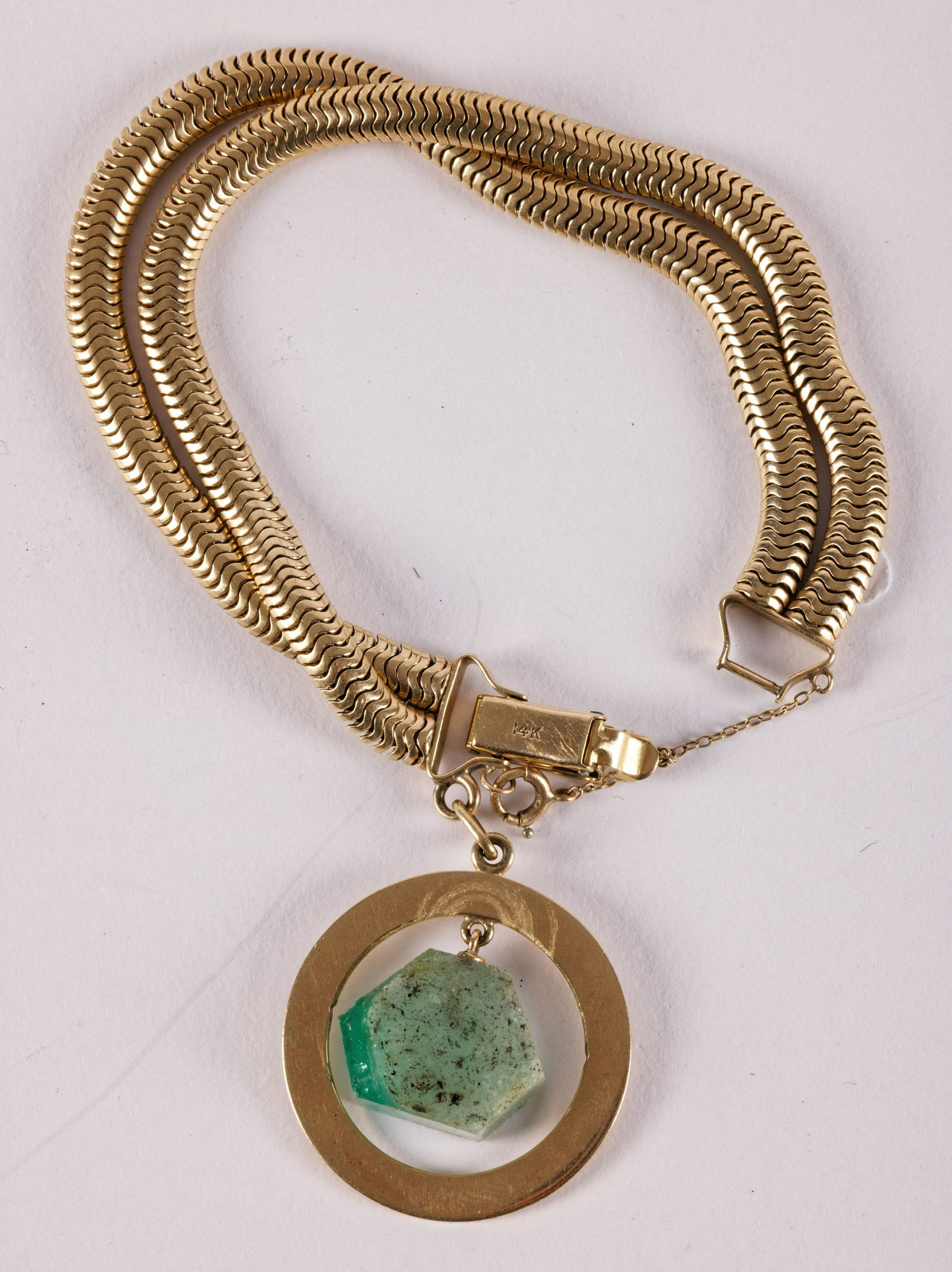 Yellow Gold Snake Chain With Emerald Slice: Yellow Gold Snake Chain With Emerald Slice14kt yellow gold double row snake chain bracelet with Touch Emerald For Luck Charm and Emerald slice. 7" long. 45 grams.From the Estate of Roberta Foloni
