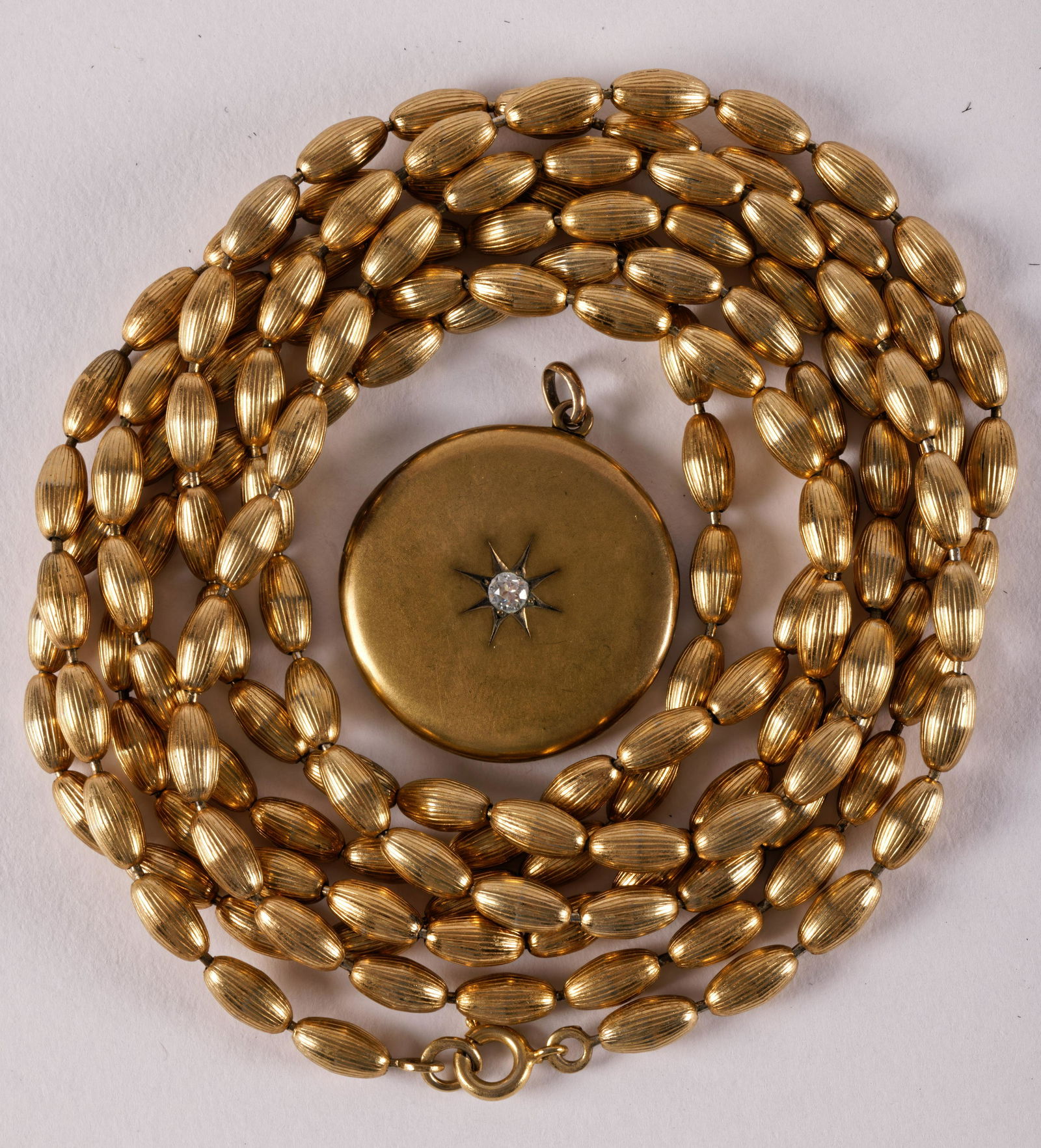 Gold Filled Bead Necklace and Locket: Gold Filled Bead Necklace and LocketGold filled oval bead necklace and gold filled diamond set locket in fair condition. length 58 inches. From the Estate of Roberta Folonie Schuetz