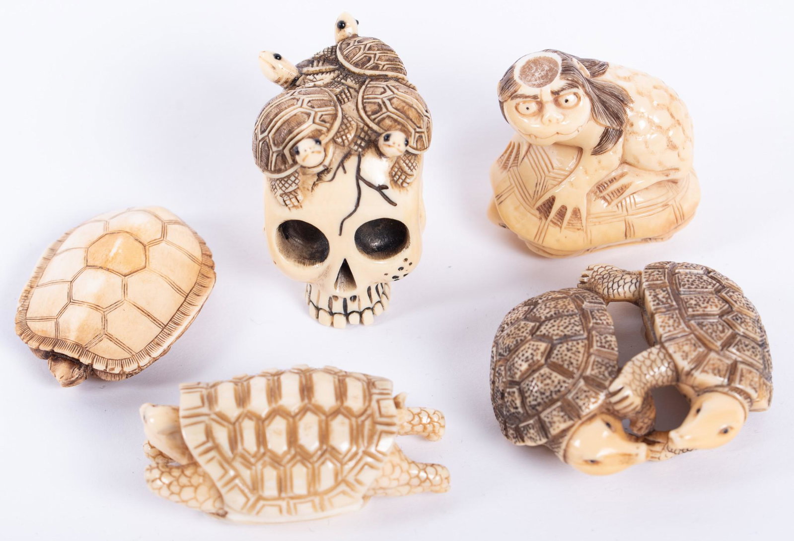A Collection of Five Antique Ivory Netsuke, all Turtles: A Collection of Five Antique Ivory Netsuke, all Turtles Including turtles on a skull, two turtles embracing, and a creature on a turtle.