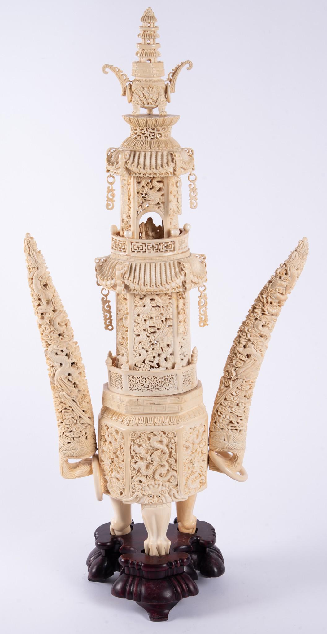 A Rare Antique Chinese Carved Bone Pagoda Temple: A Rare Antique Chinese Carved Bone Pagoda Temple A magnificent 2-part Chinese Pagoda carving. The base rising on 3 animal paws and capped with images of mythical beasts. The base's body carved with 6 