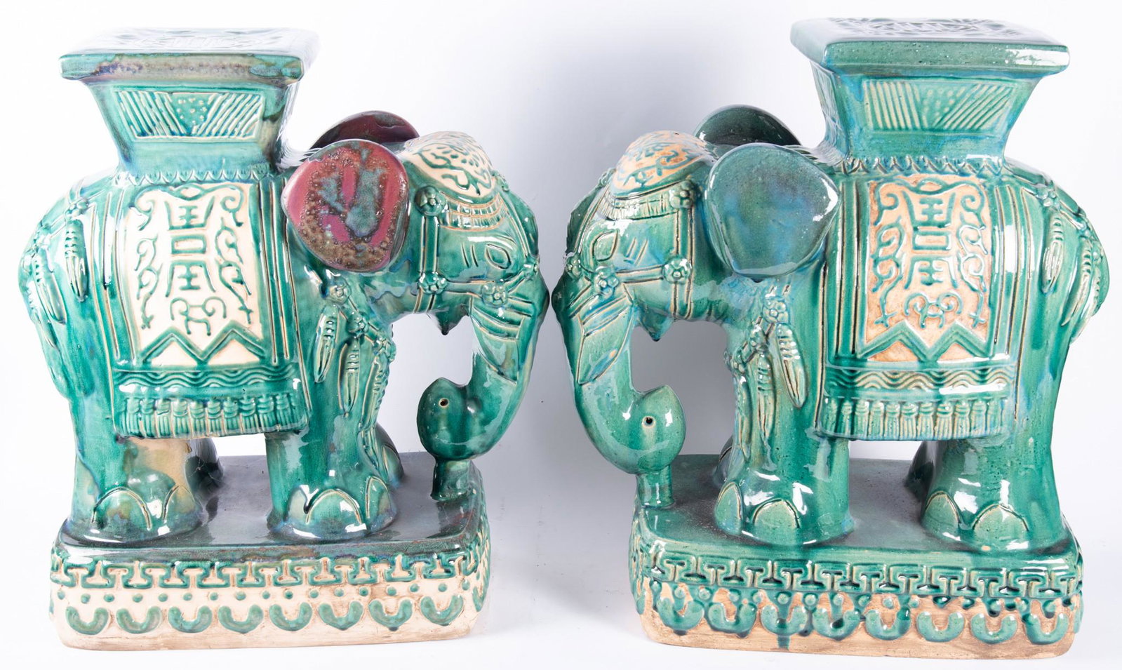 Pair of Asian Glazed Pottery Elephant Garden Stools: Pair of Asian Glazed Pottery Elephant Garden Stools Overall green glaze with tan and purple accents. Height: 24 inches