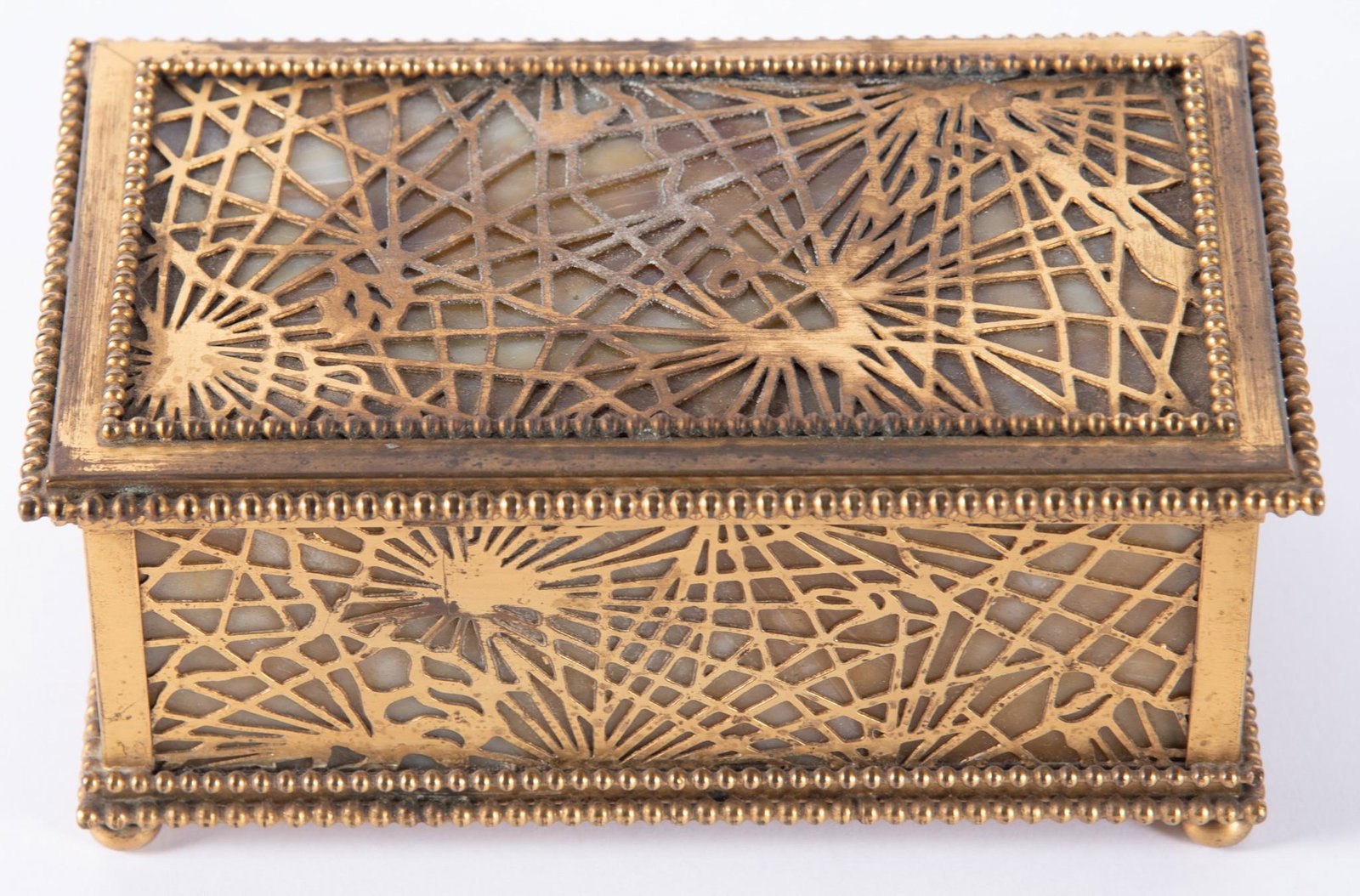 Tiffany Studios Pine Needle Box: Tiffany Studios Pine Needle Box Gilt-bronze pierced pine needle pattern over amber slag glass, marked Tiffany Studios, New York, 816 and etched 5698. Length: 6 3/4 inches; Height: 3 inches; Depth: 4 i