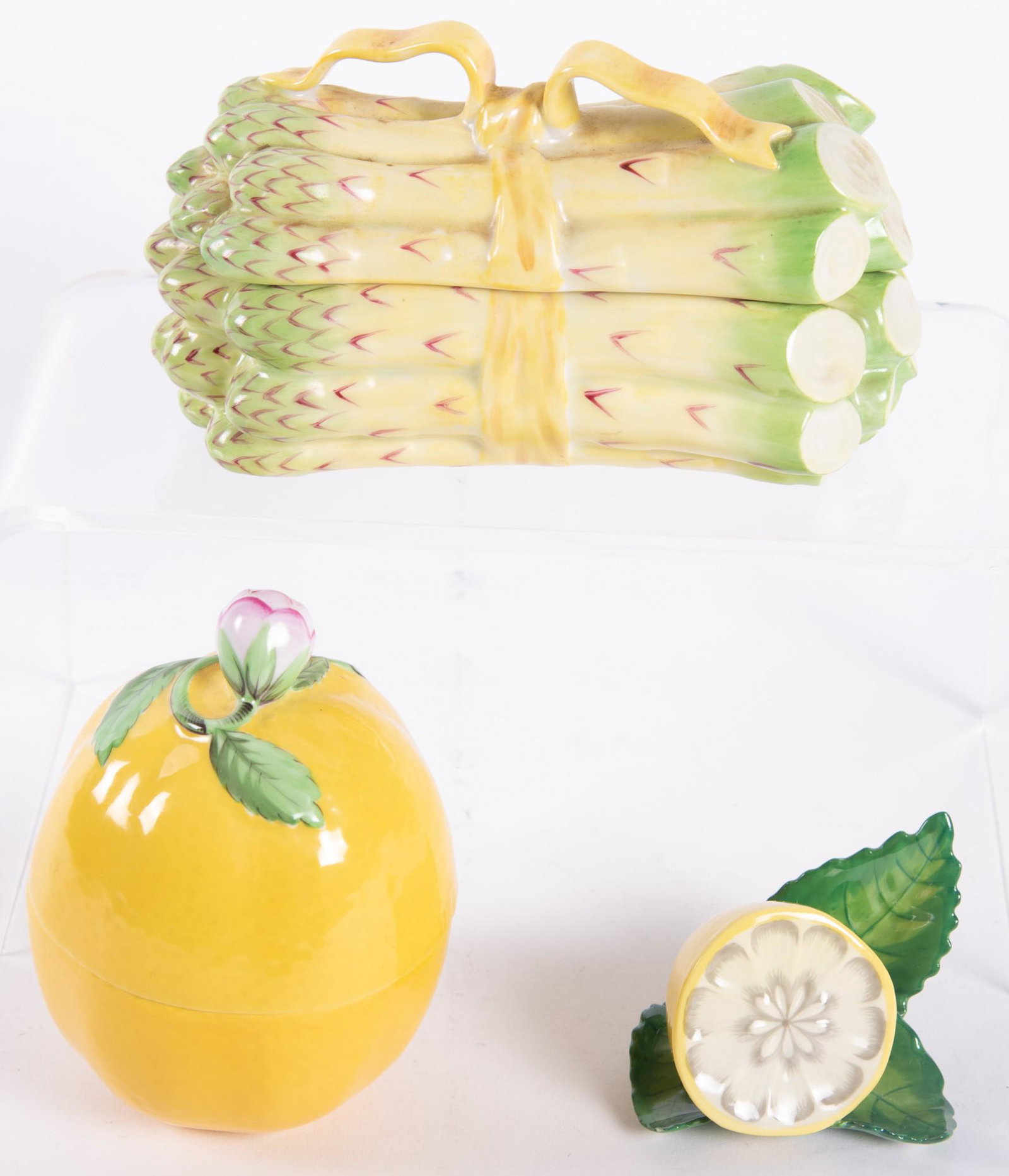 Three Pieces of Herend: Three Pieces of Herend An asparagus form lidded box, 3 x 5 inches, a lemon form box, 4 x 3 inches, and a sliced lemon, 2 1/2 x 2 inches.