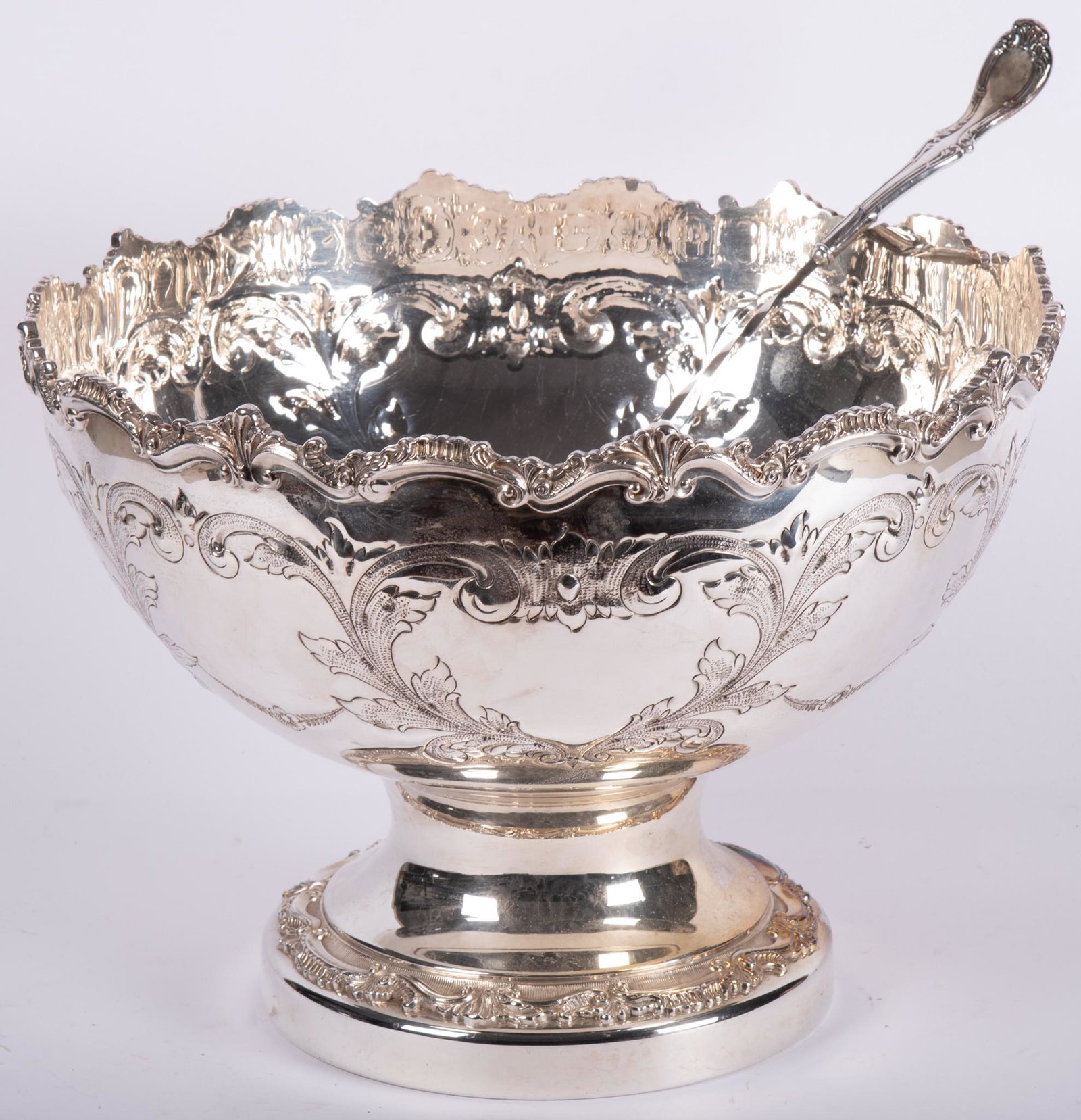 A Large Hand Chased Plated Silver Punch Bowl w Ladle: A Large Hand Chased Plated Silver Punch Bowl w Ladle Elaborately hand chased bowl with floral motif and rocaille edging. Accompanied with a plated silver ladle. Approximately 11 1/2" tall, 16&quo
