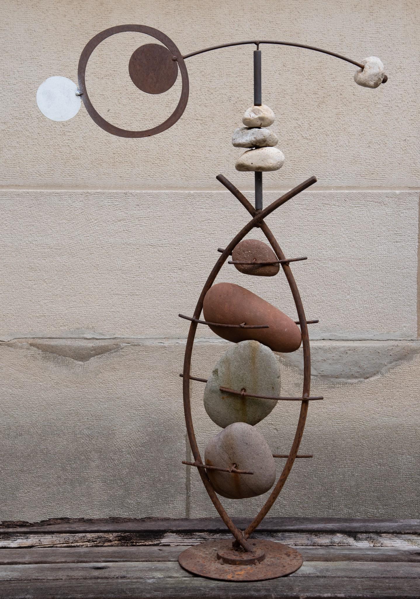 Outdoor Stone and Metal Mobile Sculpture: Outdoor Stone and Metal Mobile Sculpture Consisting of drilled stones woven with iron rods surmounted by a balancing stone and painted metal element. Height: 43 inches