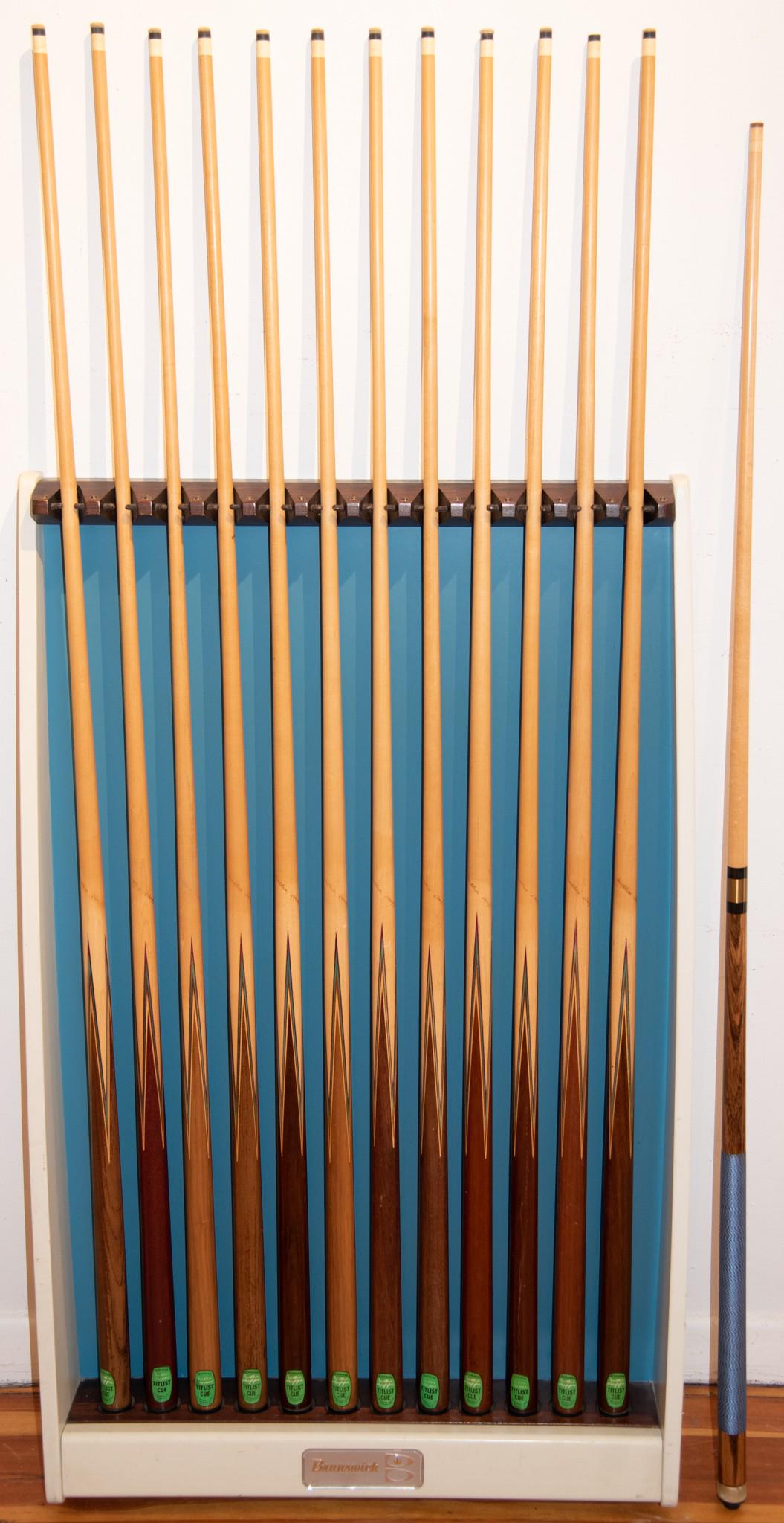 Mid-Century Modern Brunswick Gold Crown Wall-Mounted Pool Cue Rack with Thirteen Cues: Mid-Century Modern Brunswick Gold Crown Wall-Mounted Pool Cue Rack with Thirteen CuesMid-Century blue and white rack with gold crown label.44 x 29 inches