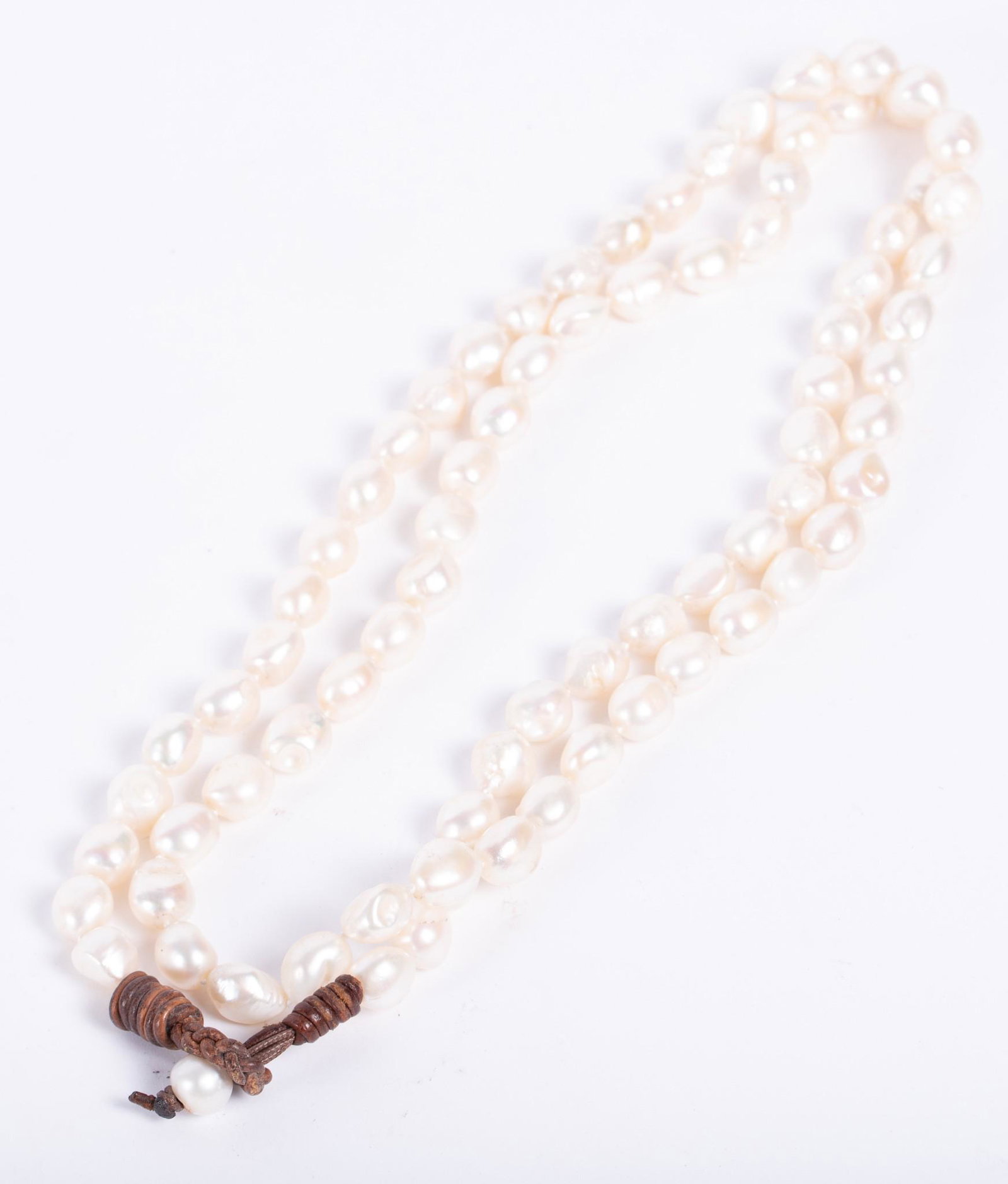 Freshwater Pearl Strand Necklace: 48" long large freshwater pearls with leather clasp. Custom designed.