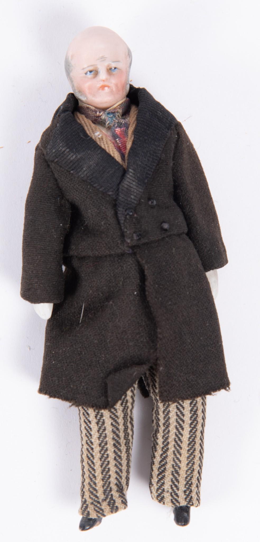 Bisque Molded Head and Limbs Male Cloth Doll, 5": Bisque Molded Head and Limbs Male Cloth Doll, 5"Cloth body, dressed in a tuxedo with striped pants. He is the doll house grandfather. Wrinkles, bald top and gray hair mutton chops.