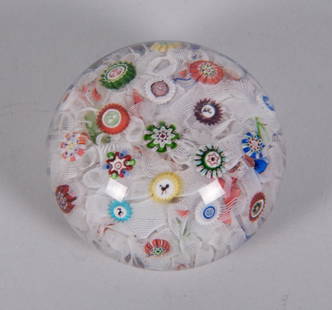 An Antique Baccarat Millefiori and Gridel Figure Paperweight: An Antique Baccarat Millefiori and Gridel Figure PaperweightFrance, with date canes for 1849, the spaced millefiori Baccarat weight with numerous animal form canes and opaque filigree work. Note: The