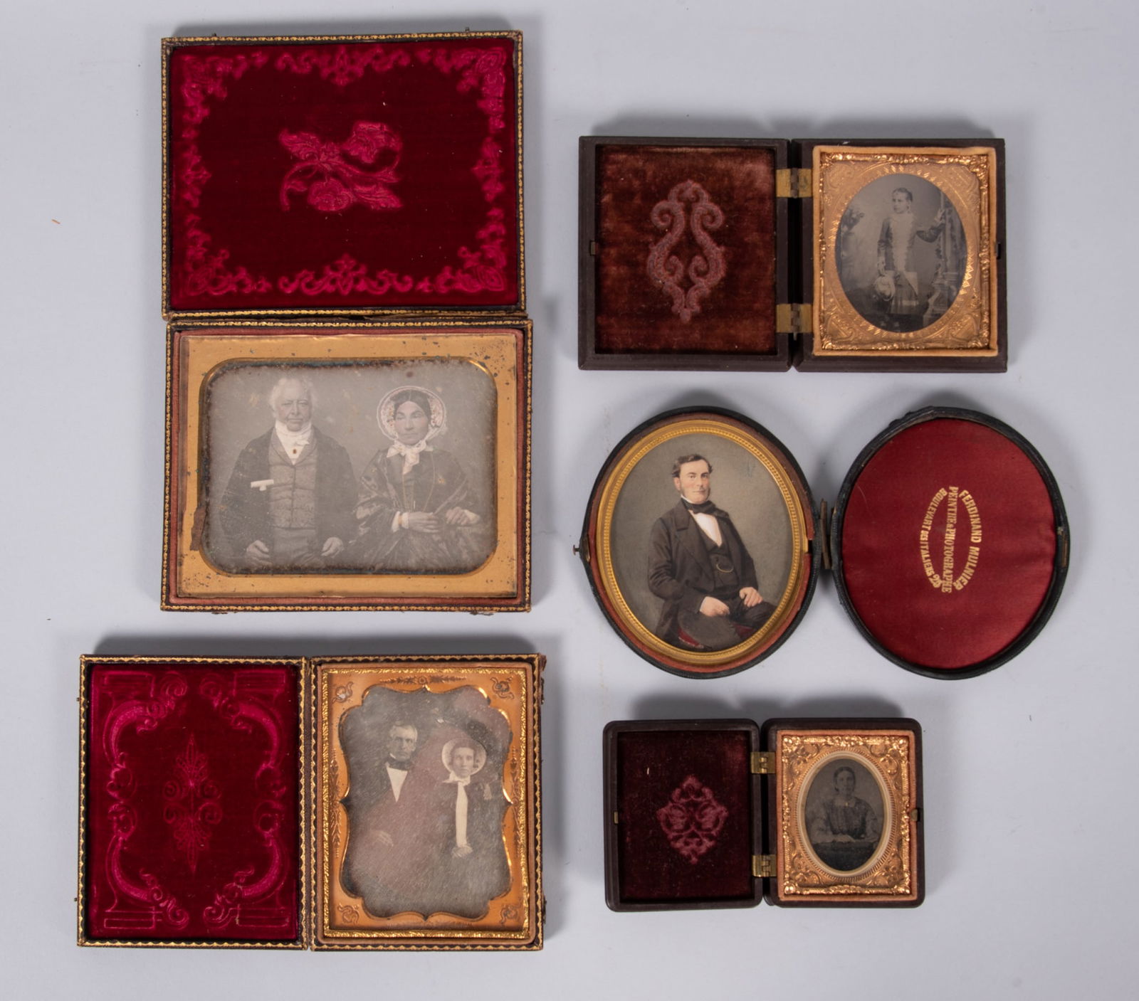 A Collection of Five 19th Century Photographic Portraits: A Collection of Five 19th Century Photographic PortraitsA half-plate daguerreotype of a woman in a full bonnet and jewelry, seated with a gentleman holding a walking cane. A quarter-plate daguerreotyp