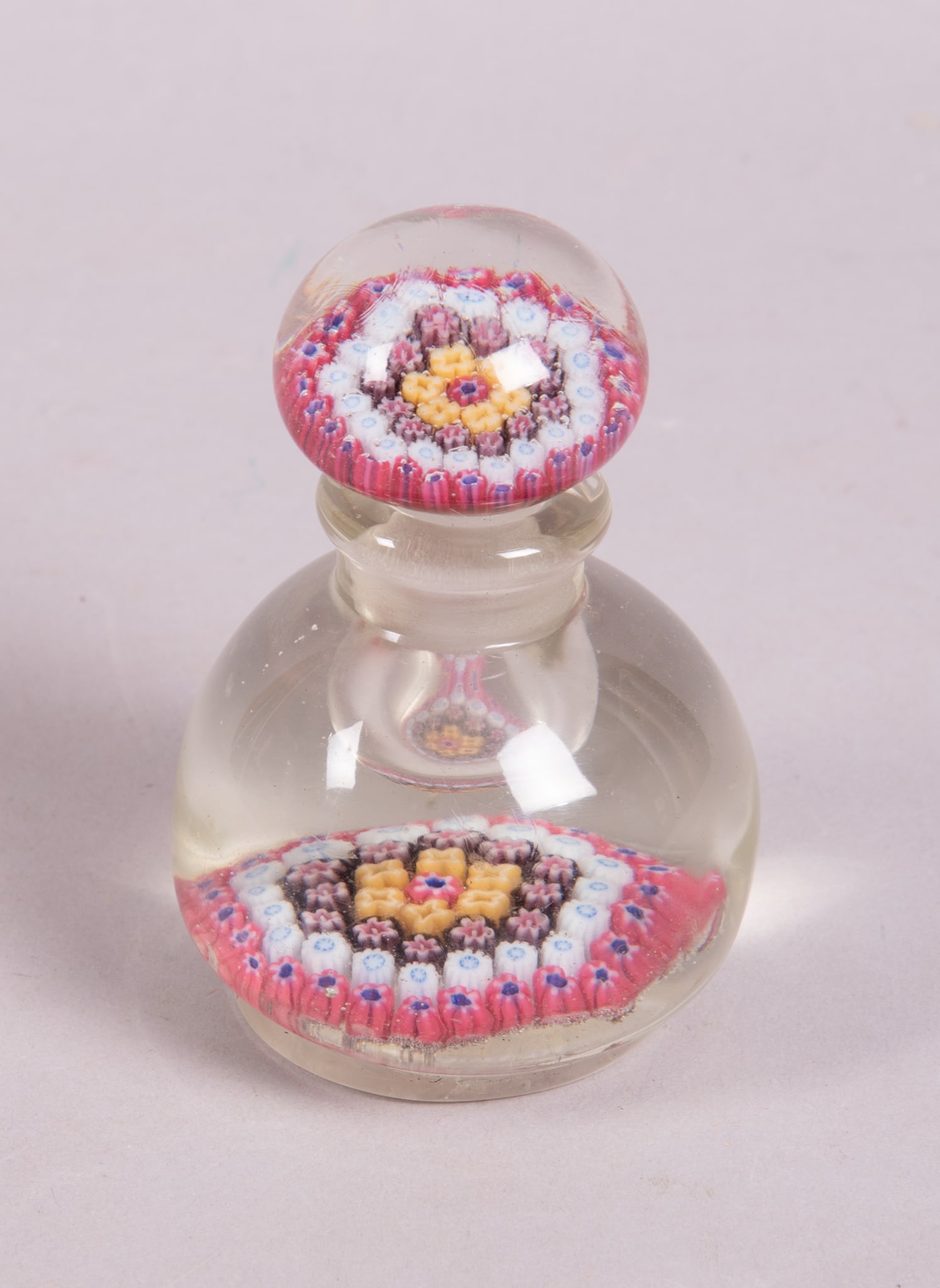 Vintage Murano Art Glass Perfume Bottle: Vintage Murano Art Glass Perfume Bottle 1930?s Murano art glass perfume bottle with stopper. Round clear glass with a carpet of concentric millefiori glass cane circles of 5 different colors. The stop