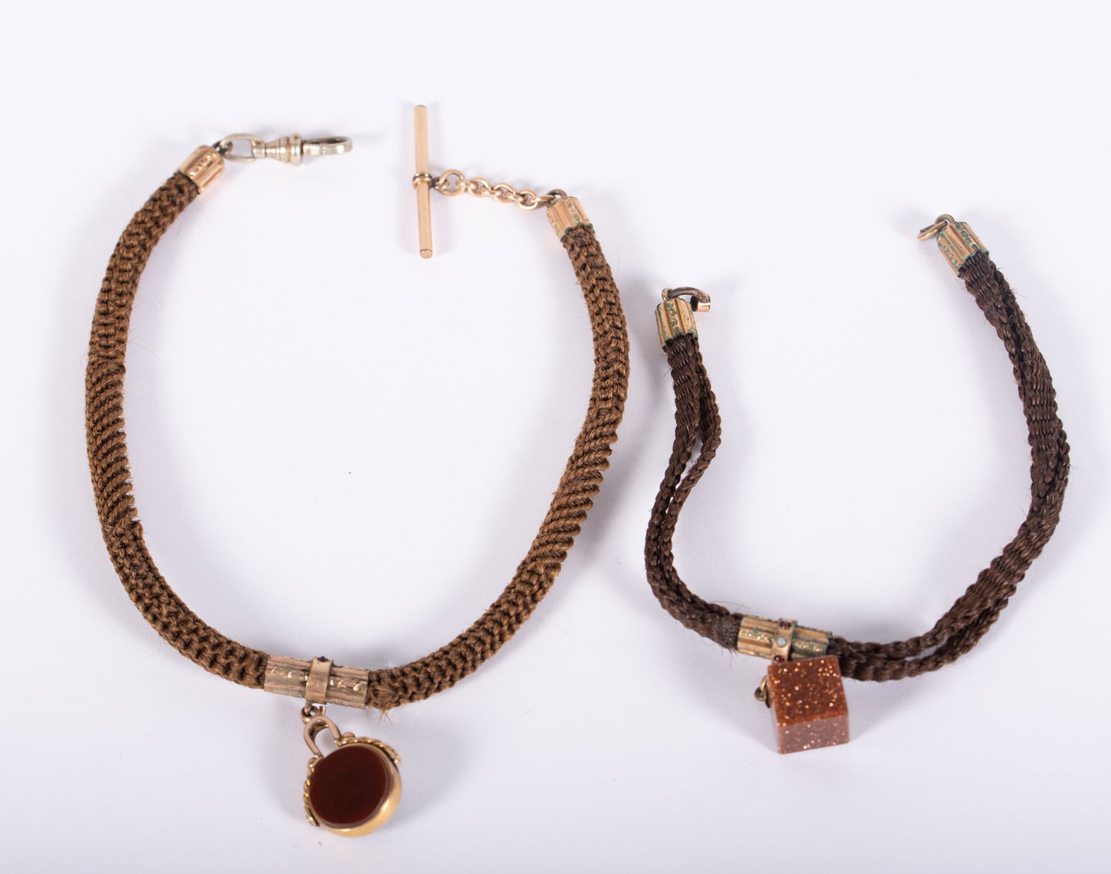 Victorian Hairwork Watch Chains with Fobs: Victorian Hairwork Watch Chains with Fobs Lighter brown hair chain has gold filled swivel fob set with bloodstone on one side & carnelian on the other, it is held by a gold mounting set with garnet & 