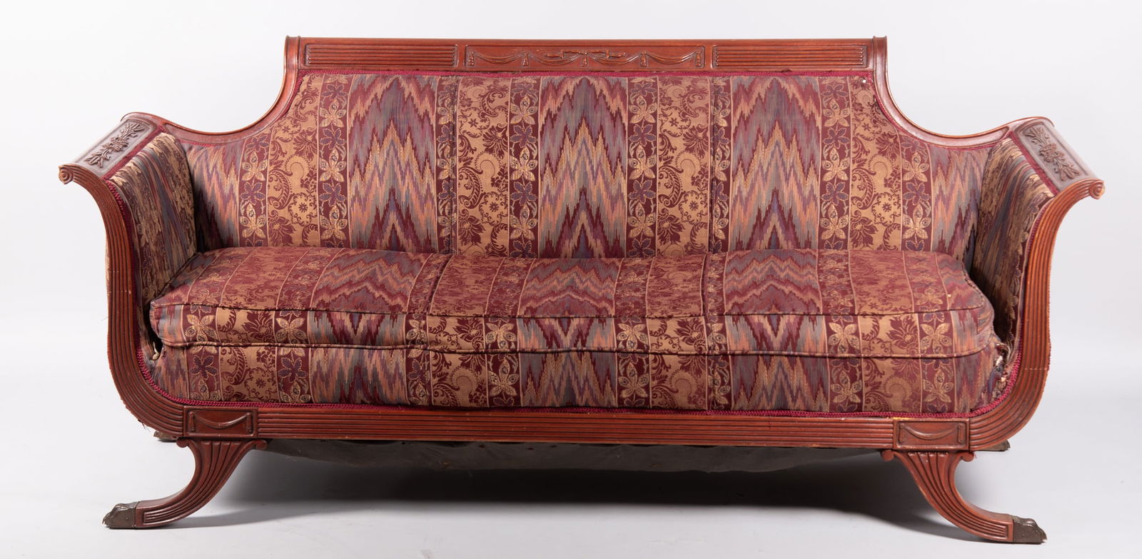Semi Antique Duncan Phyfe Sofa: Semi Antique Duncan Phyfe SofaScrolled and fluted head rail with swags of garland above an upholstered back and seat centering outward scrolled arms with wheat decoration all above a reeded seat rail