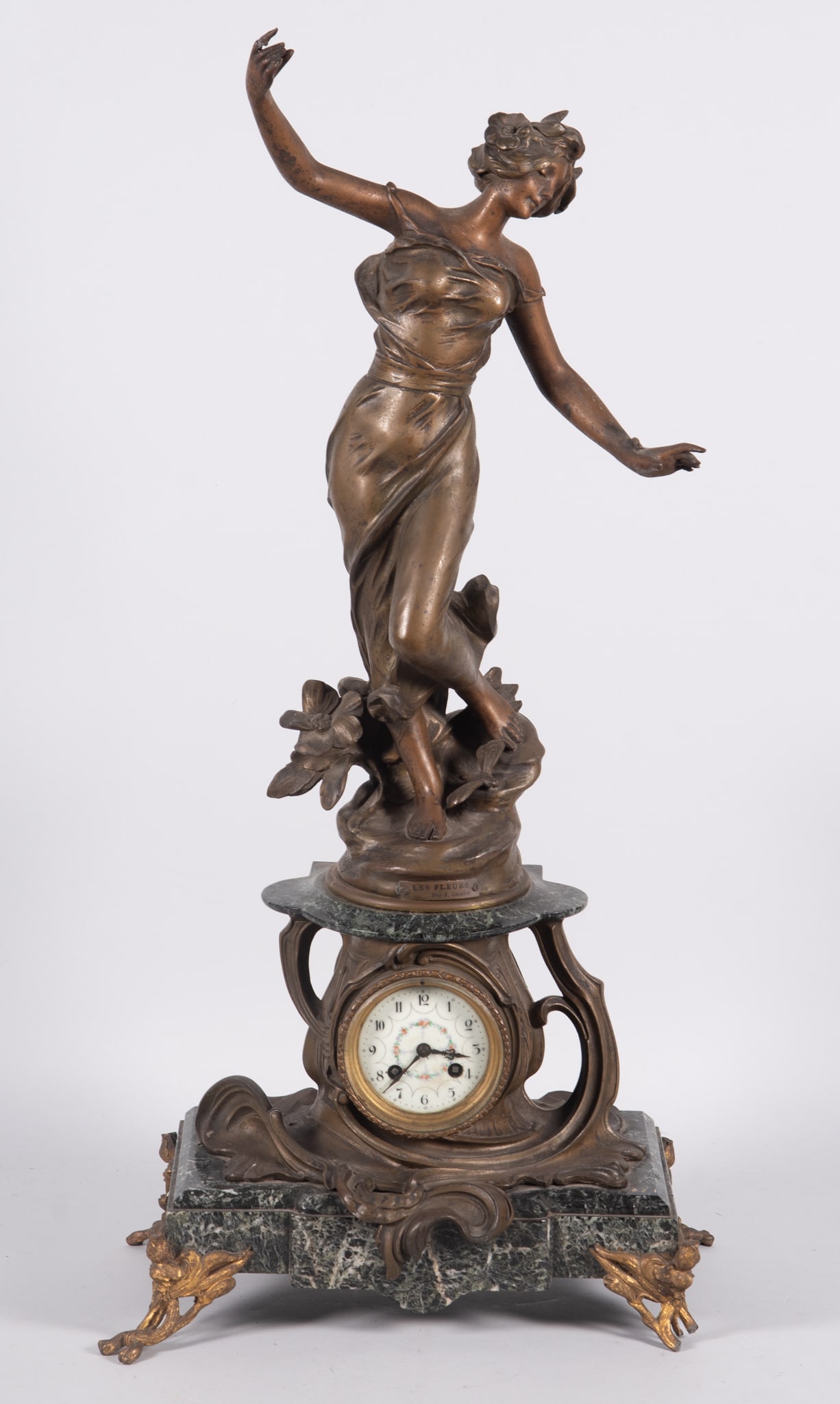 An Art Nouveau Figural Spelter Clock "Les Fleurs", after J Causse: An Art Nouveau Figural Spelter Clock "Les Fleurs", after J Causse,France, late 19th/early 20th century, a tall figural Art Nouveau mantel clock. The green mottled-marble base rising on four