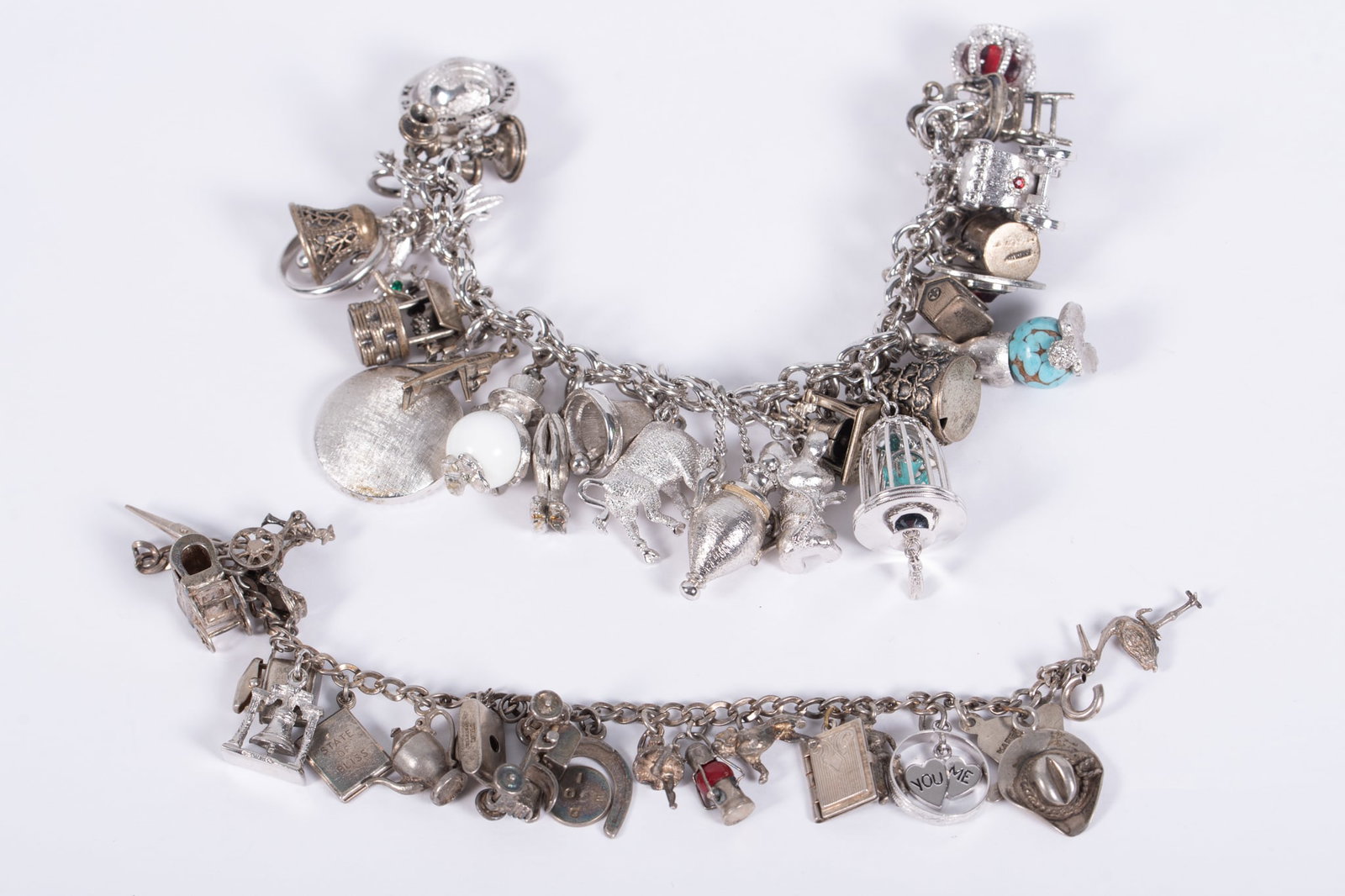 Two Extraordinary Silver Charm Bracelets: Two Extraordinary Silver Charm BraceletsBoth chain bracelets are sterling and 7" in length. Many of the charms are sterling and all are very unusual.
