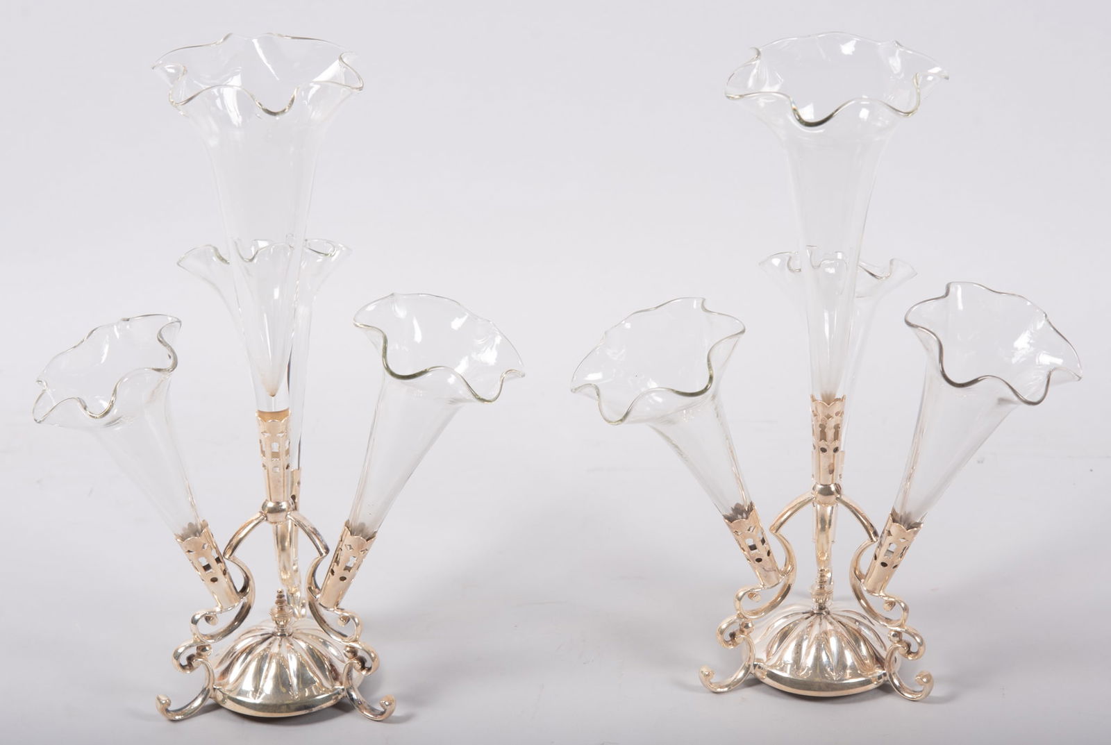 A Pair of English Edwardian Style Plated Silver and Glass Epergnes: A Pair of English Edwardian Style Plated Silver and Glass EpergnesA pair of 12 1/2in tall 3-arm silver plated and glass table epergnes. The arms with open-work holders and sinuous shaped supports. Goo