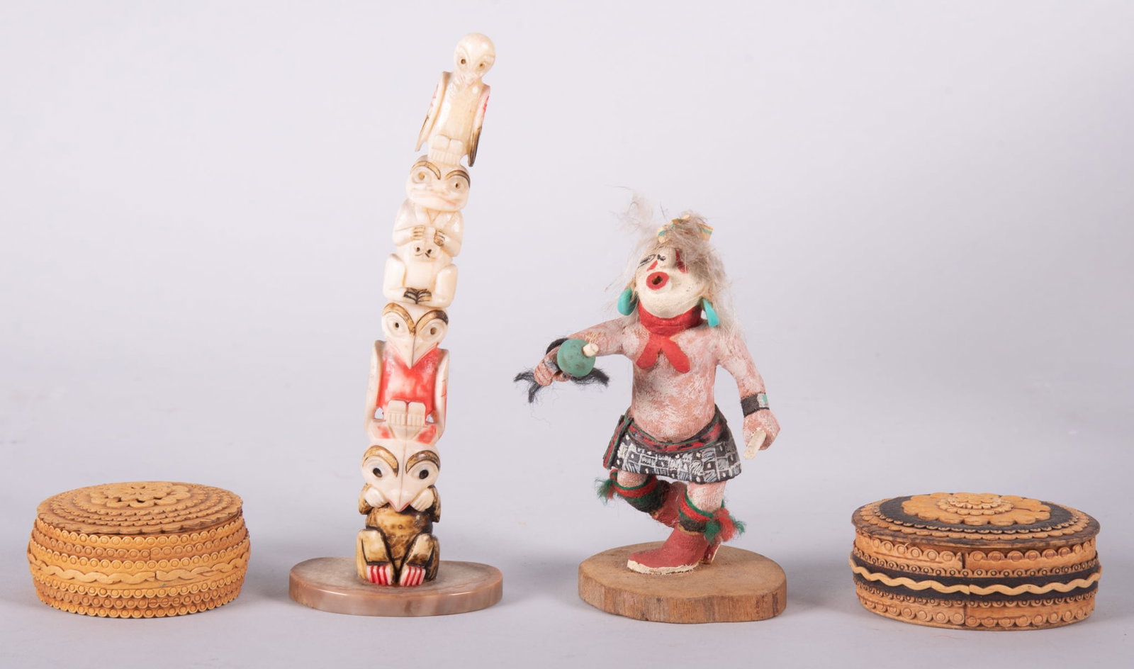 A Collection of Northwest Tribal Pieces: A Collection of Northwest Tribal Pieces The lot includes a signed miniature kachina doll, Wilburt Talashoma(sp?), a 6 inch tall carved bone totem, and two intricately carved maple small boxes.