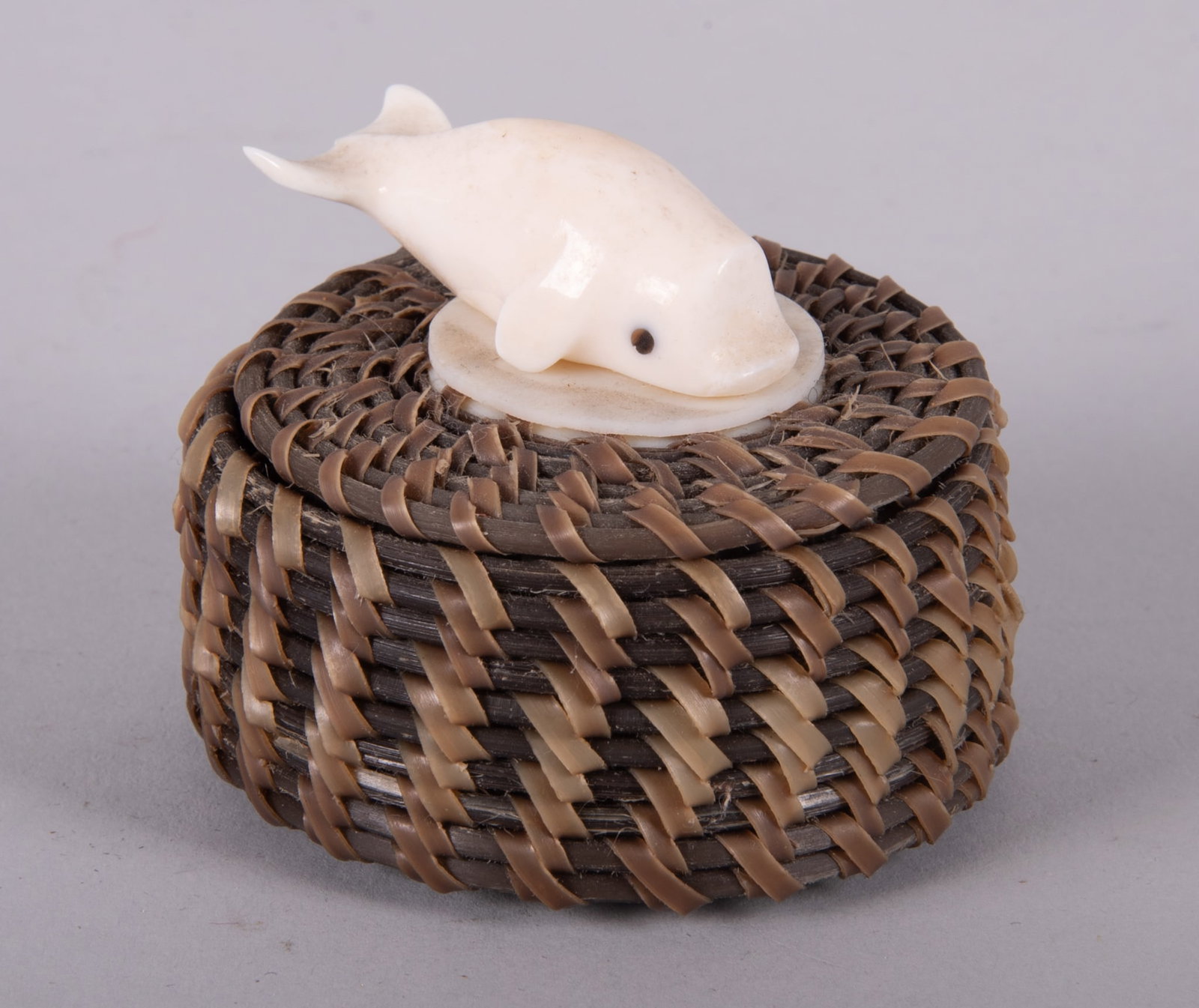 A Good Eskimo, John Hank, Coiled Baleen Miniature Basket: A Good Eskimo, John Hank, Coiled Baleen Miniature Basket Inupiaq, signed John Hank, basket with coiled baleen and miniature carved whale on the lid. 2 inches tall, 2 1/2 inches diameter