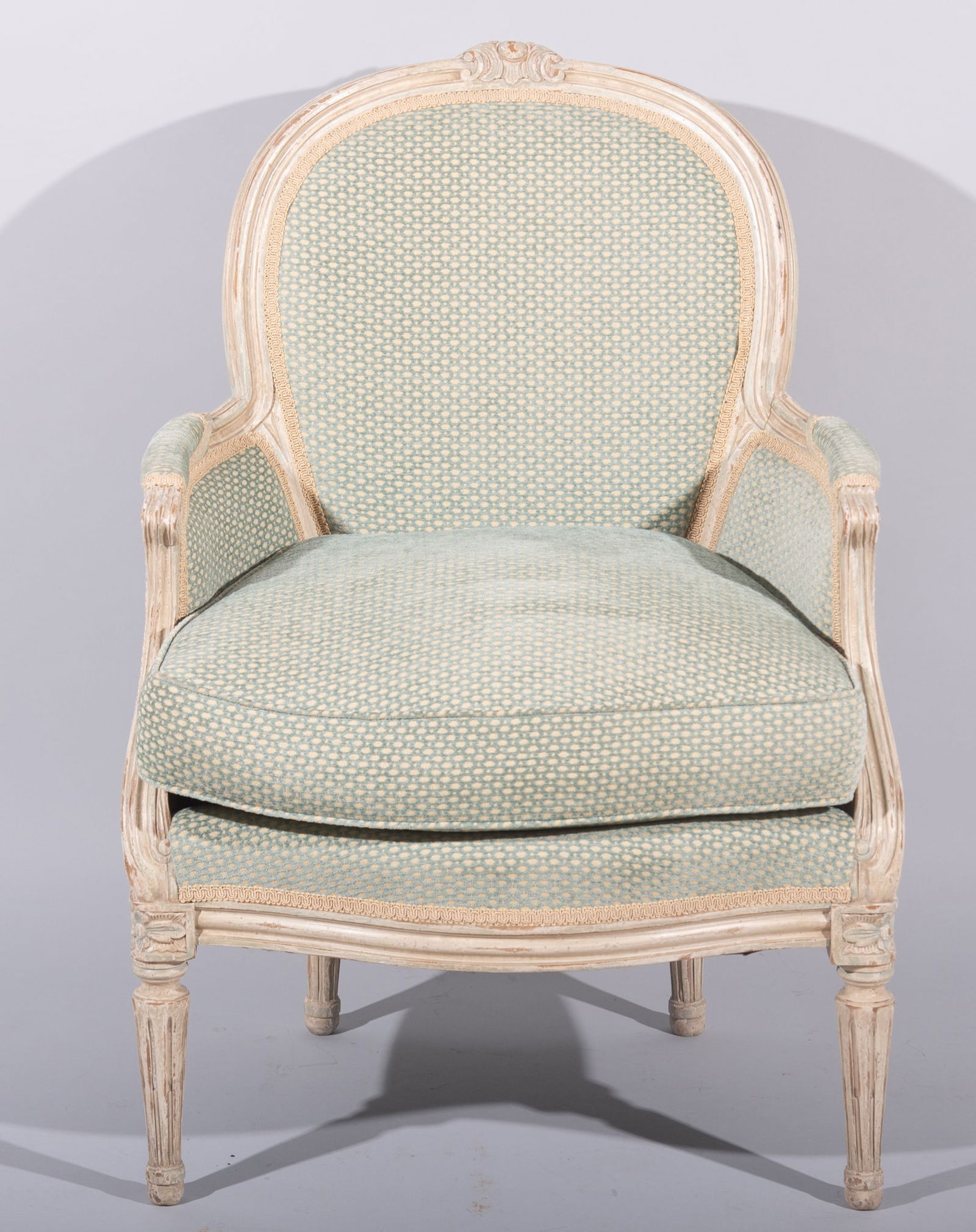 Louis XVI Design Creme Lacque Bergere: Louis XVI Design Creme Lacque BergereCarved head rail with shaped and upholstered back rest above a matching seat centering a pair of shaped and padded arms with sloping supports ending on tapering fl