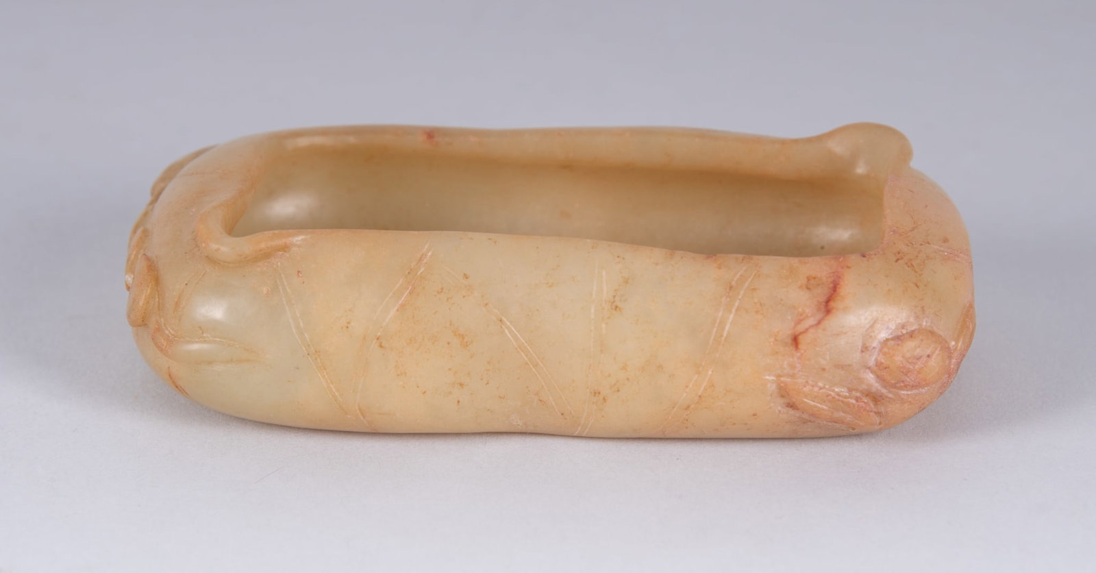 A Chinese Yellow Jade Brush Washer: A Chinese Yellow Jade Brush Washer China, a rectangular shaped brush wash in the form of a lotus blossom. Provenance: From the Collection of Juliana Yuan, Professor of Asian Art History, University of