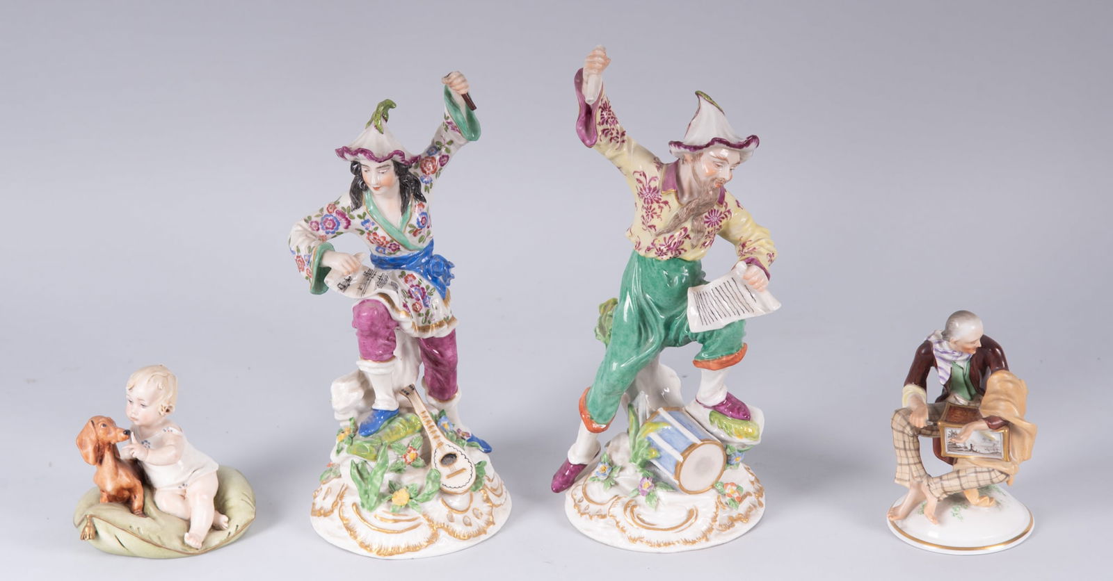 A Collection of Continental Porcelains, includes Hoechst and Vienna: A Collection of Continental Porcelains, includes Hoechst and ViennaThe collection of four porcelains includes a 10 inch tall pair of Hoechst Chinoiserie figures with musical instruments, colorful cost