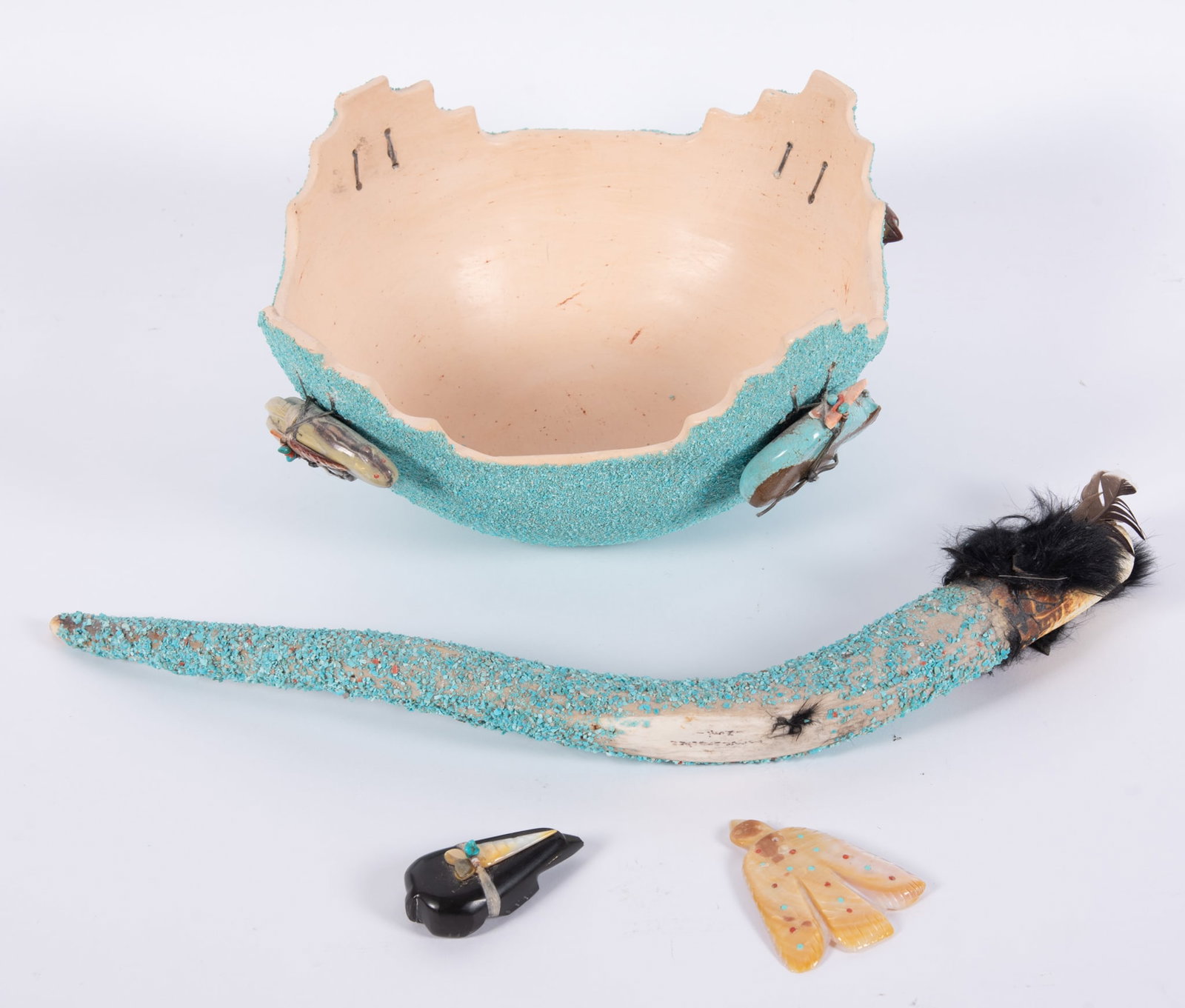 Zuni Turquoise Encrusted Fetish Bowl: Zuni Turquoise Encrusted Fetish Bowl Zuni pottery bowl with crushed turquoise coating. Four fetishes surround the bowl, and two loose fetishes are inside. A signed, turquoise coated and feathered horn