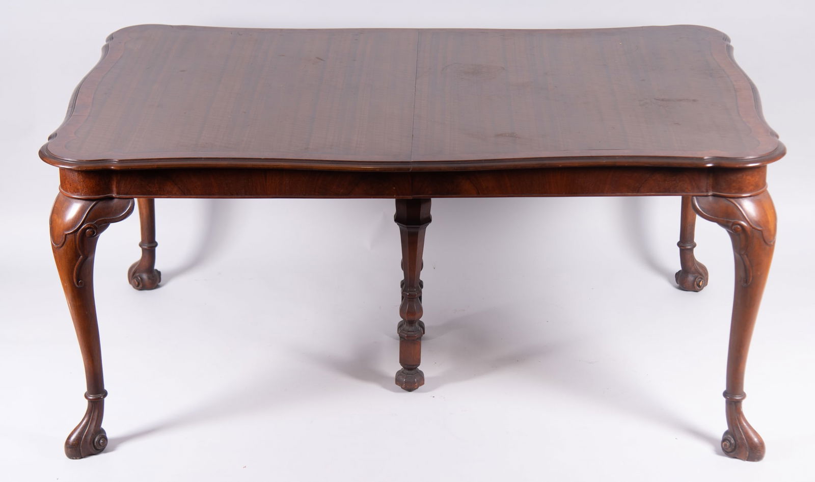 Seven Piece Dining Room Set: Seven Piece Dining Room SetThe table with serpentine and crossbanded top supported on shaped legs and carved feet. (one leaf). Six chairs, two arms and four sides, in the Chippendale style with shaped