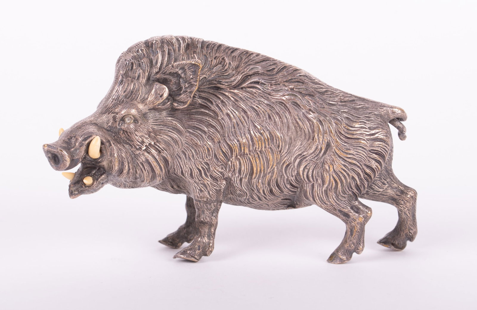 A Silvered Bronze Figure of a Boar: A Silvered Bronze Figure of a Boar Late 19th/early 20th century, a naturalistically modeled figure of a snarling boar. The tusks of carved bone, with crystal eyes. 2 3/4 inches tall, 4 1/2 inches wide