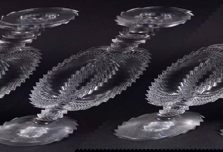 A Pair of Lalique Malmaison Pattern Candlesticks: A Pair of Lalique Malmaison Pattern CandlesticksFrance, mid-20th century, a pair of heavy sticks with crystal bobeches in Lalique's double wreath Malmaison design. The bobeche allows for a smaller dia