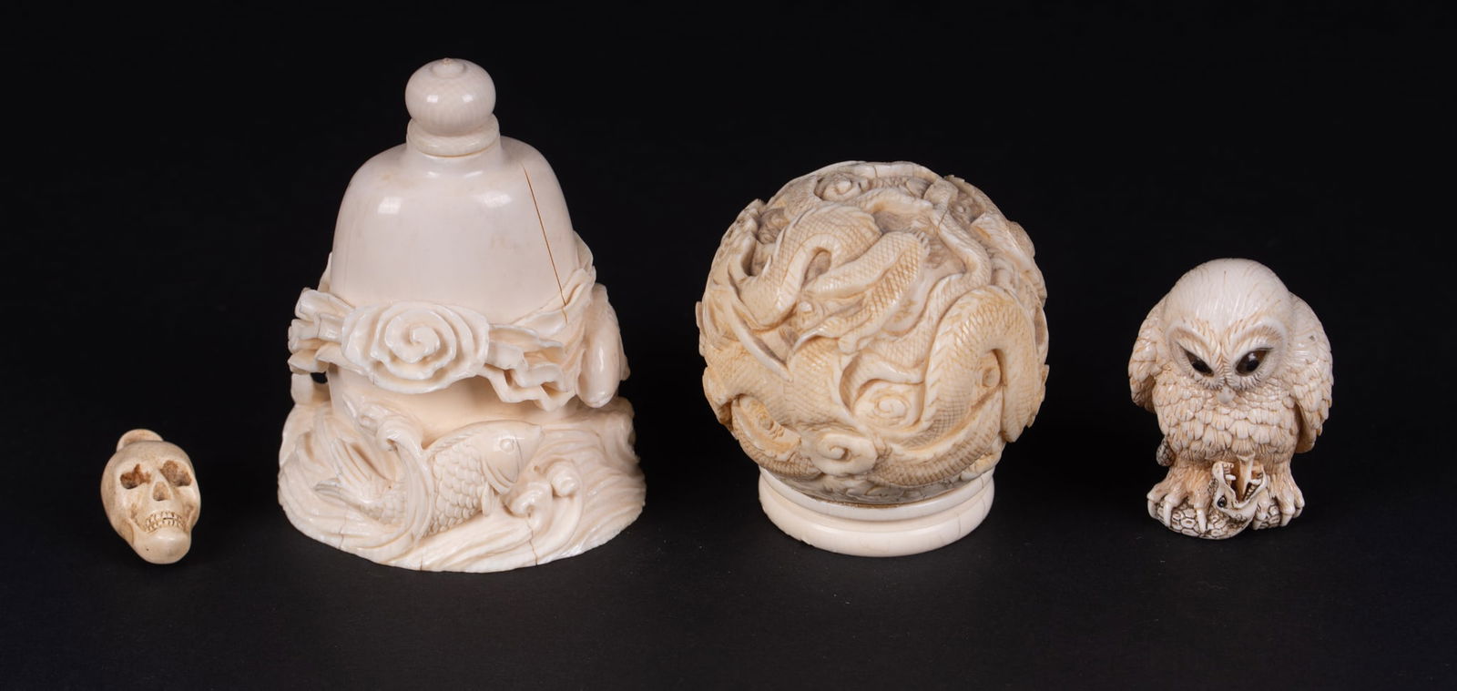 Four Japanese Carved Bone Objects: Four Japanese Carved Bone ObjectsA snuff bottle depicting koi leaping from the waves, a well carved netsuke of an owl capturing a snake, a small carved skull, and a well detailed dragon ball.tallest 2