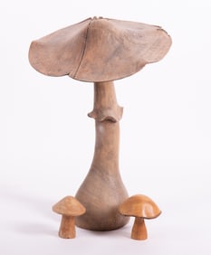 A Massive Carved Wood Mushroom Sculpture, Accompanied by Two Smaller Versions