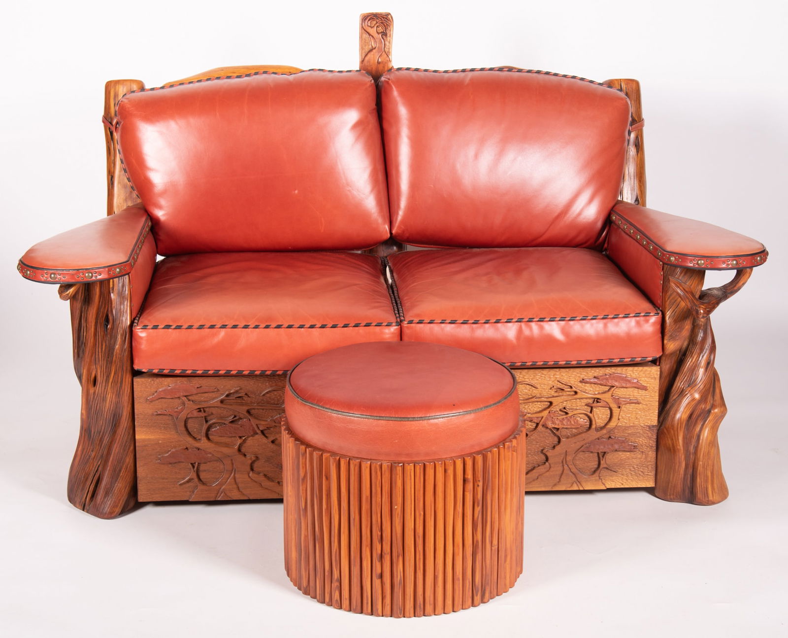 Lester Santos Western Leather Settee and Ottoman: Lester Santos Western Leather Settee and OttomanThe frame made of driftwood with shaped head rail above a leather upholstered back and seats centering a pair of paddle arms with tack upholstery on nat