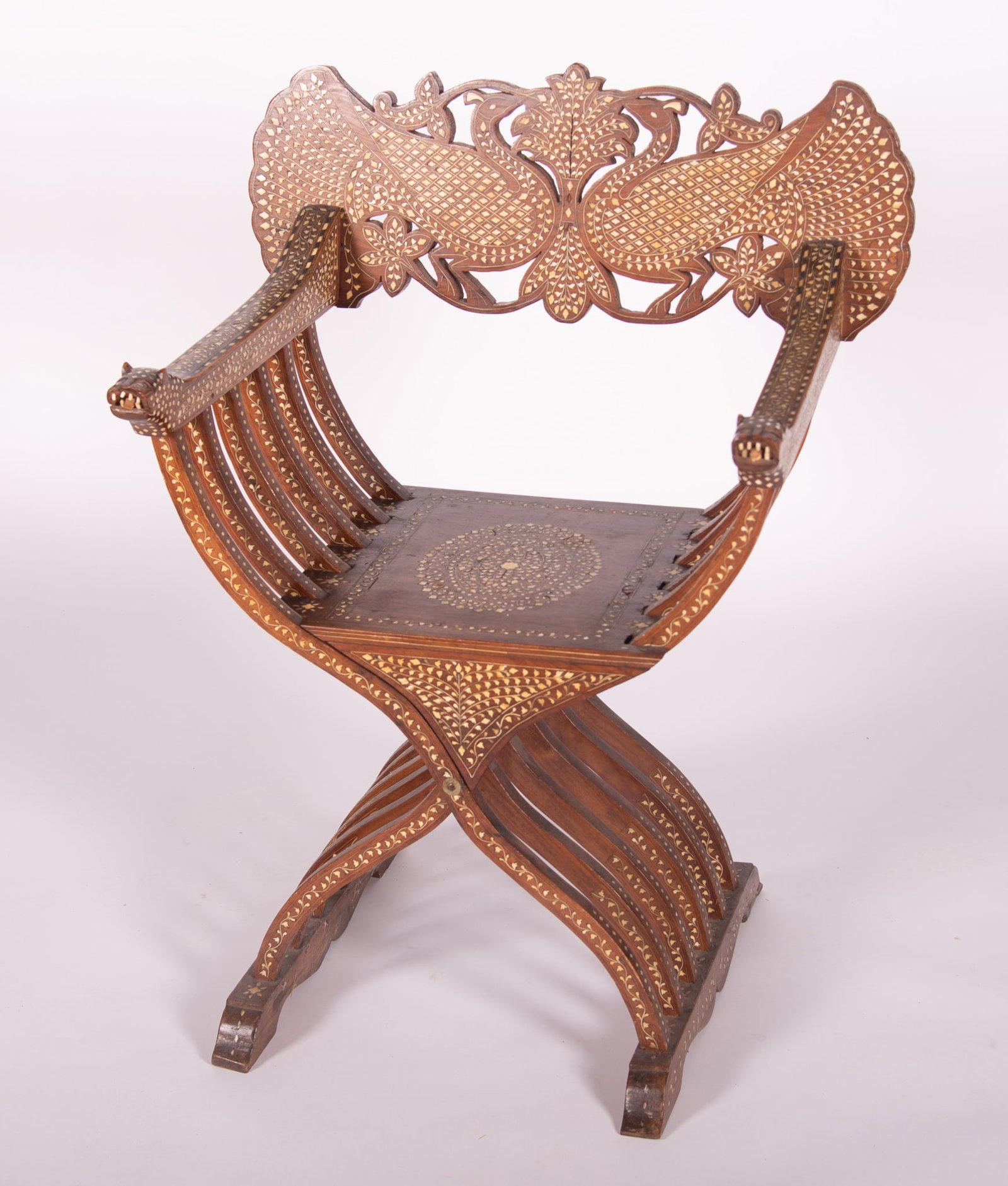 Middle Eastern Savonarola Chair: Middle Eastern Savonarola Chair With bone inlay designs and animal form arms with shaped back rest of floral design and spindled sides and legs. 38 x 29 1/2 inches
