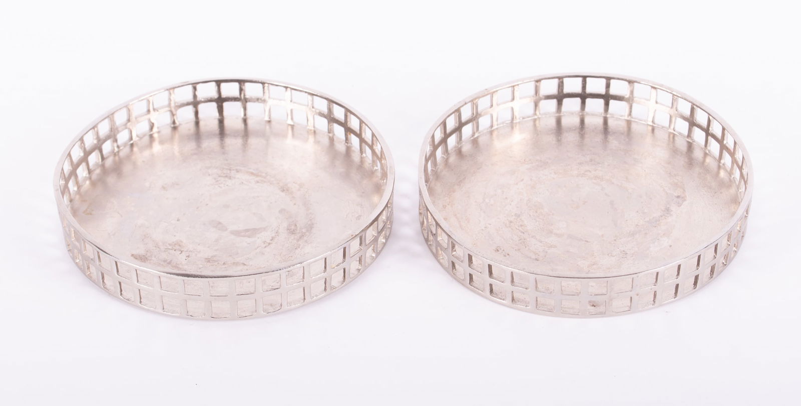 A Pair of Secessionist Style Wine Coasters: A Pair of Secessionist Style Wine CoastersFrom the circa 1905 design by Josef Hoffman, a pair of nickel plated pewter coasters retailed by Neue Galleries, NY.5 1/8 inch diameter